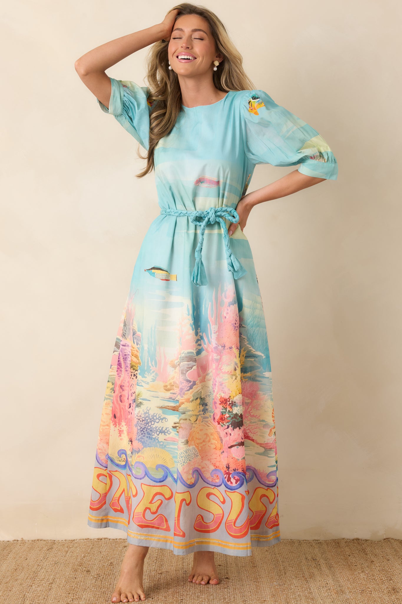 Cotton maxi dress with round neckline, adjustable waist tie, and relaxed silhouette.