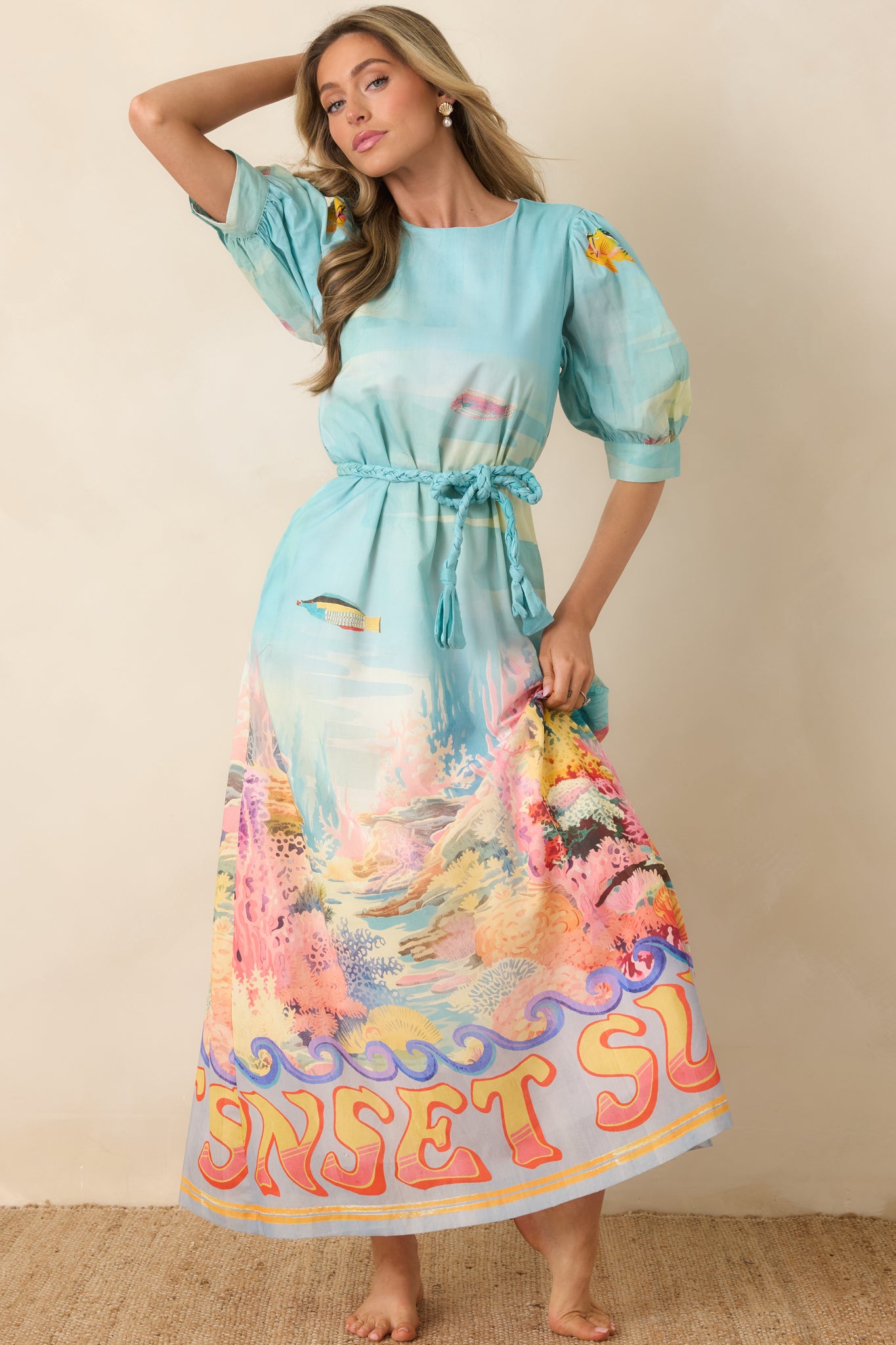 Relaxed-fit maxi dress with soft puff sleeves and flattering tie-waist silhouette.