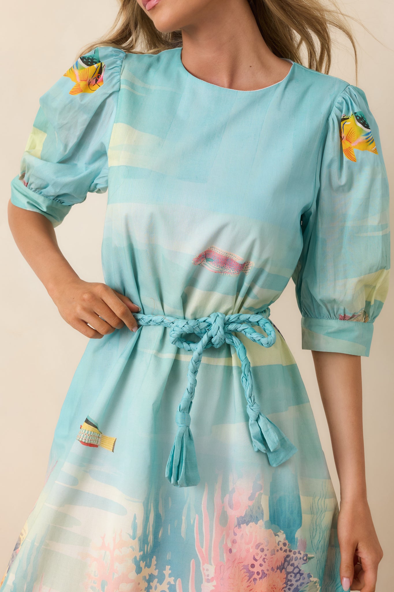 Detailed view of the adjustable tie waist and gathered fabric shaping the maxi dress silhouette.