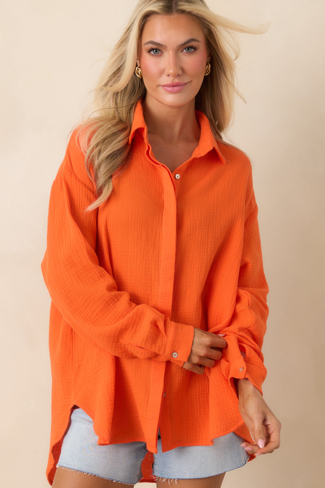 Slightly oversized cotton top with front buttons and subtle textured finish.