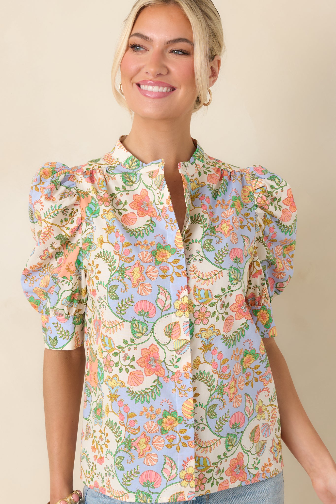 Front detail emphasizing the voluminous short sleeves and crisp cuffs that define the blouse’s polished silhouette.