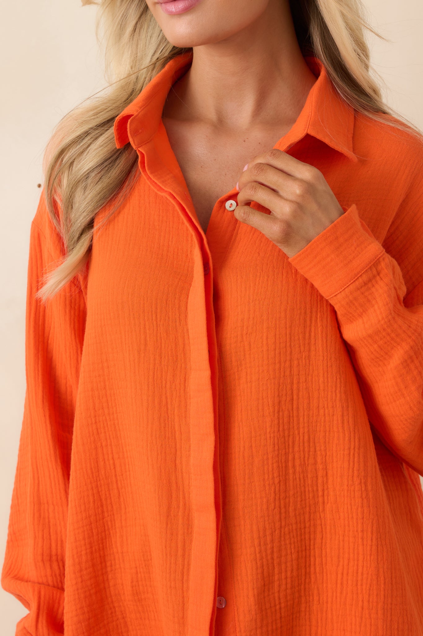 Detailed view of the button-front closure, gauze fabric texture, and roll-tab sleeve detail.
