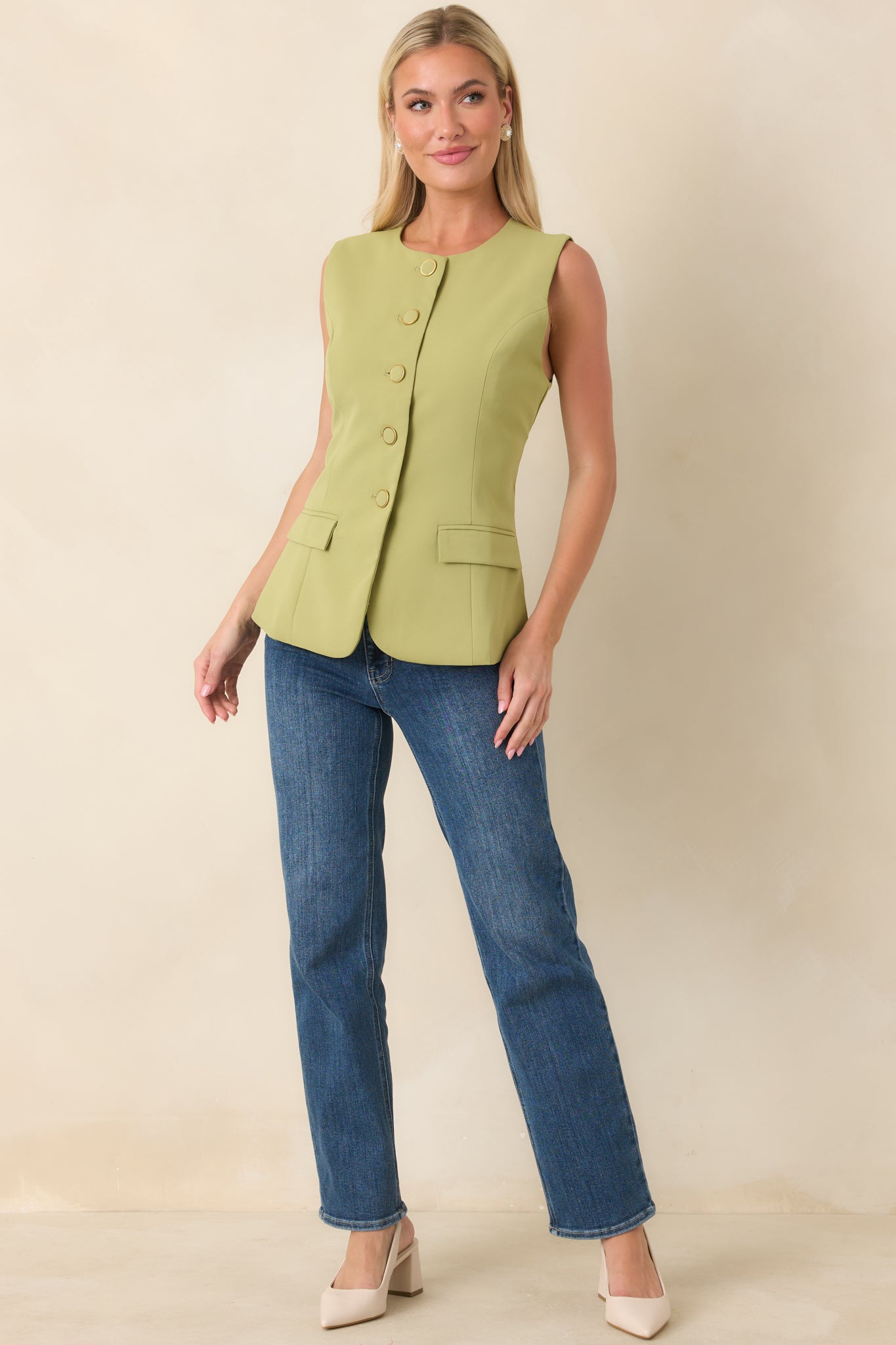 Structured green sleeveless top featuring princess seam detailing, faux welt flap pockets at the hip, and a sleek full-length button front.
