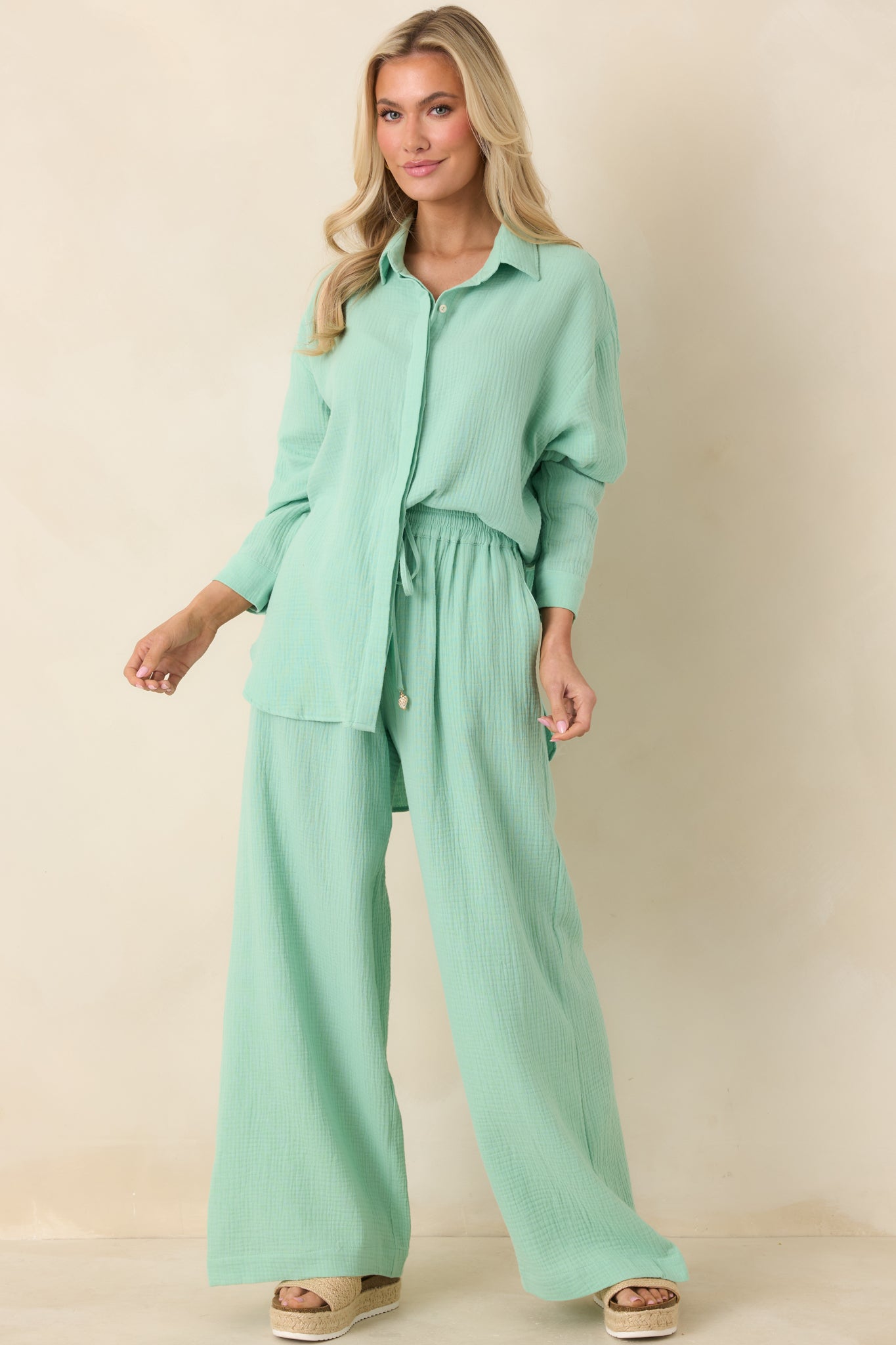 Lightweight gauze-style pants in seafoam green featuring a relaxed wide-leg fit and soft drape through the leg.