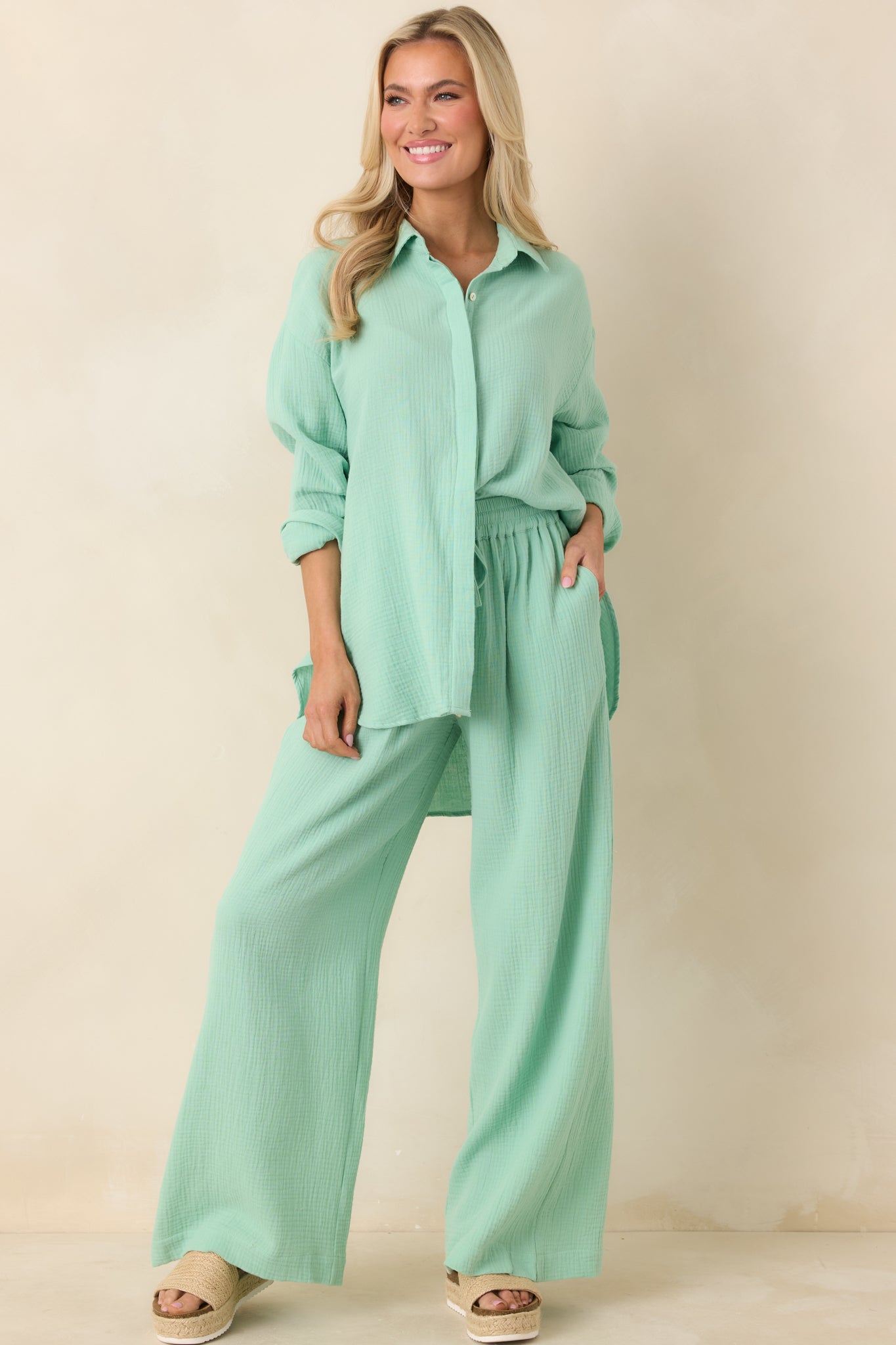 Seafoam green full-length pants designed with side pockets, elastic waist, and breezy wide legs for effortless movement.