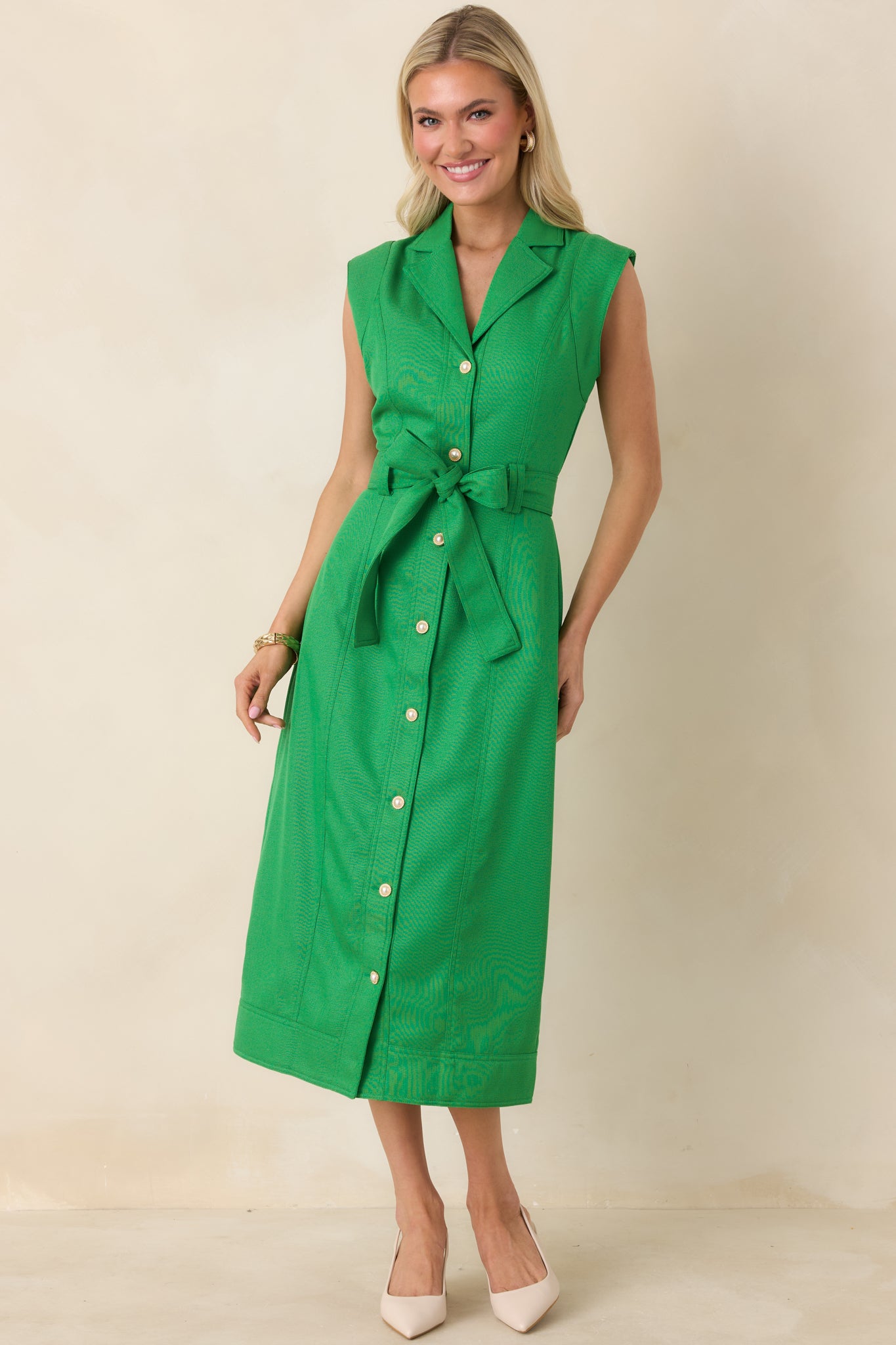 Sleek sleeveless midi dress with button closure, tied waist belt, and versatile fitted silhouette.