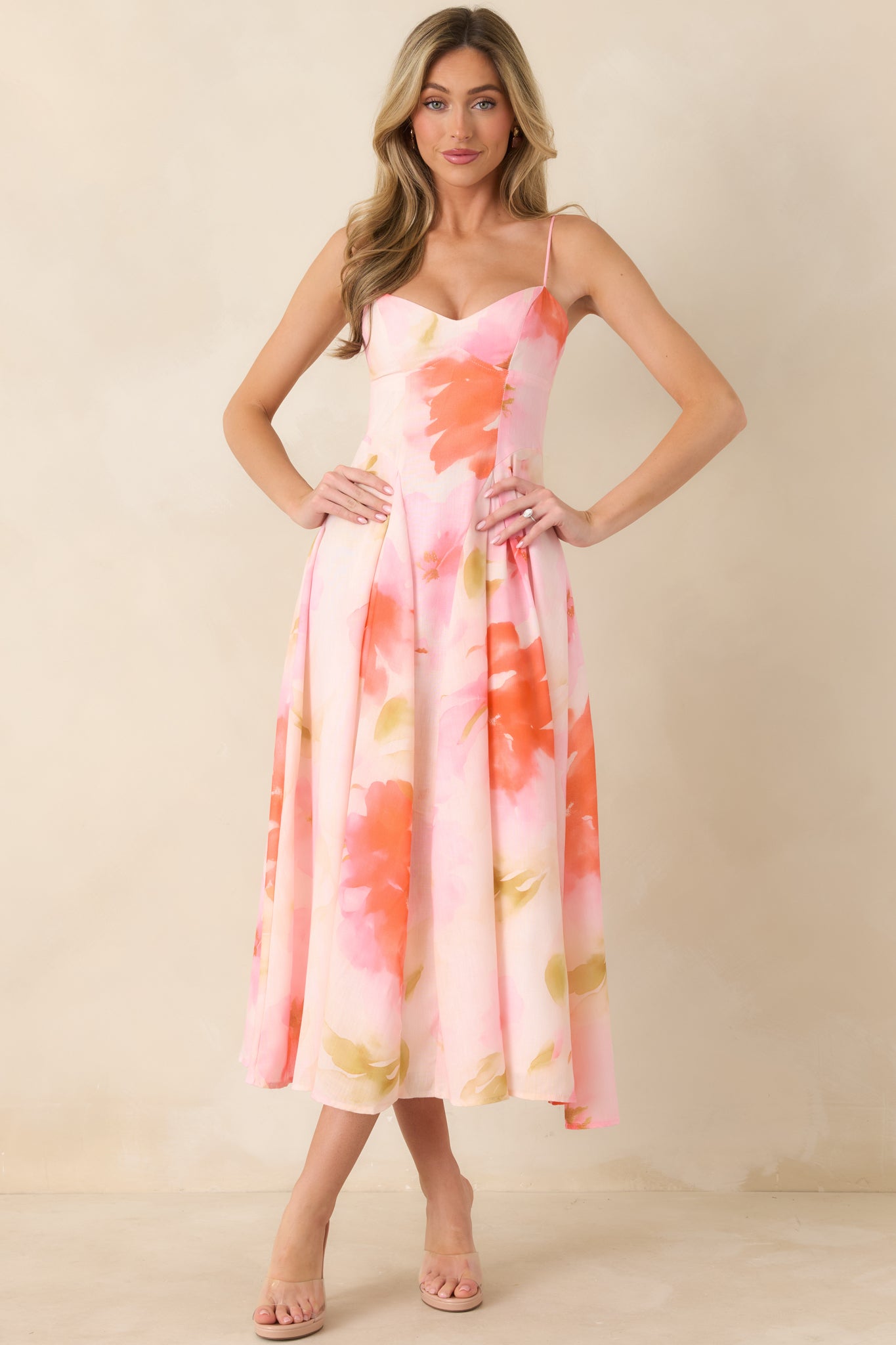 Feminine midi dress with structured bodice, adjustable straps, and flowy hem creating elegant motion.