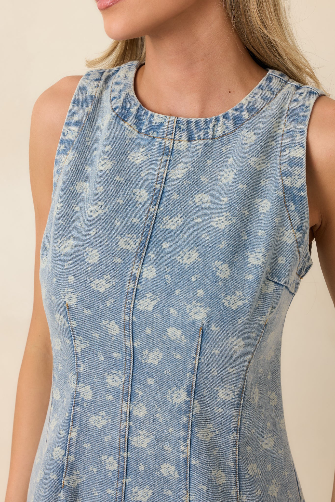 Detailed view of the floral print texture, seam construction, and smooth denim finish.