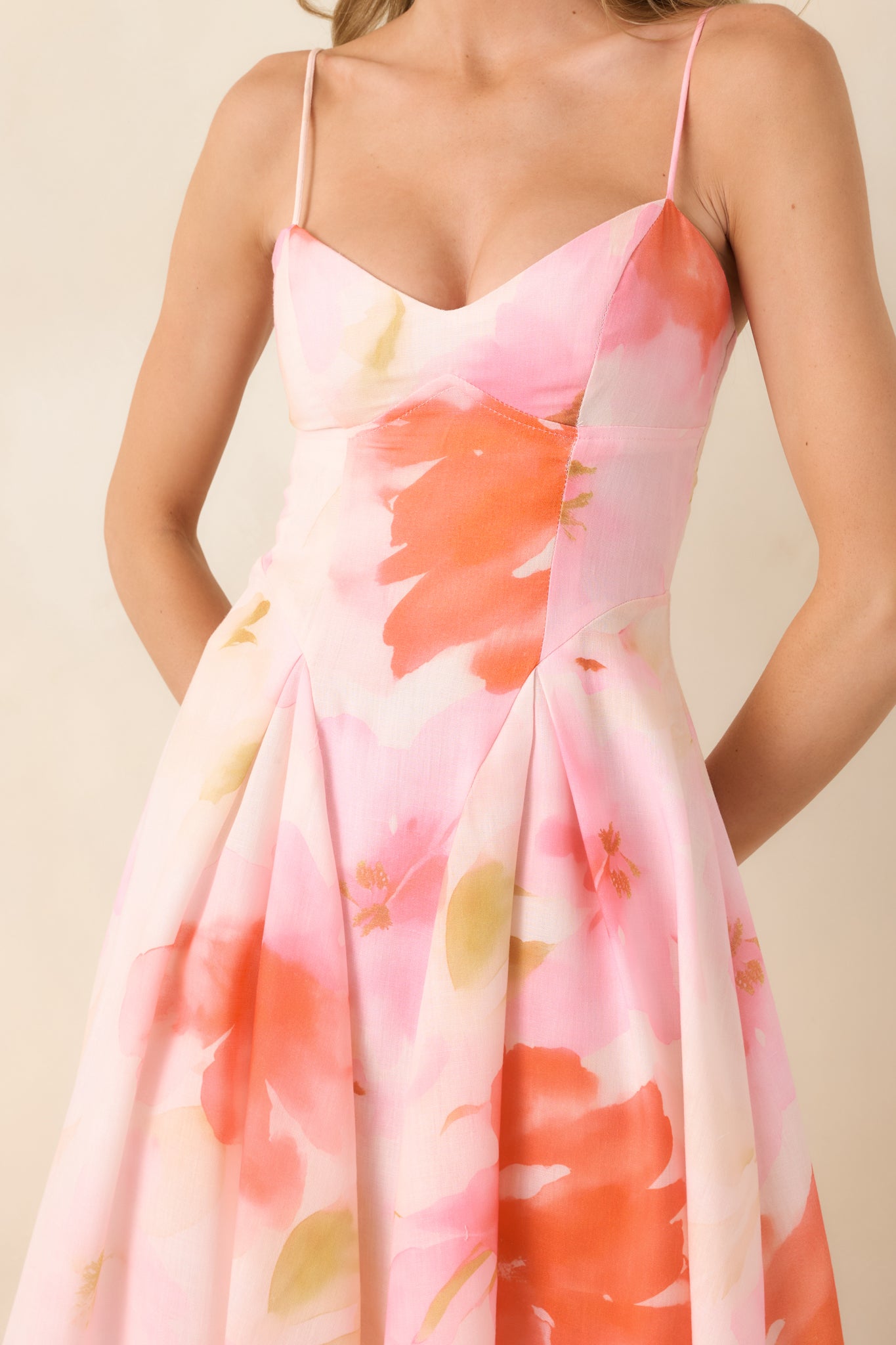 Close-up of structured sweetheart-inspired neckline and adjustable spaghetti straps in woven fabric.