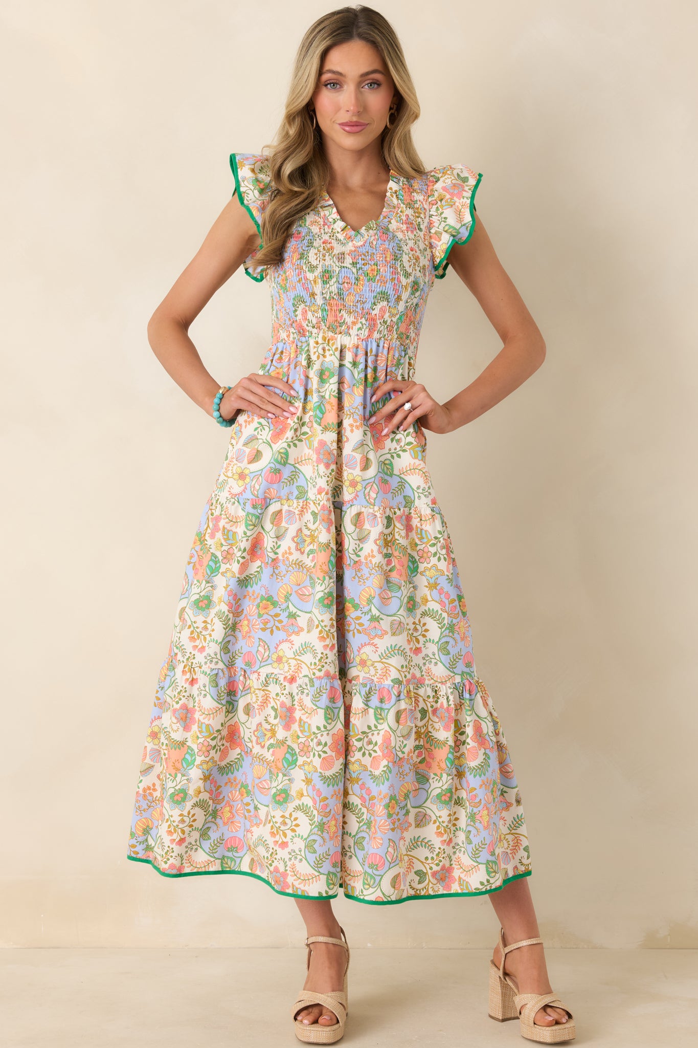 Lightweight cotton maxi dress with a vibrant floral paisley print, featuring a stretchy smocked bodice, ruffle-trimmed cap sleeves, and a flowing tiered skirt.