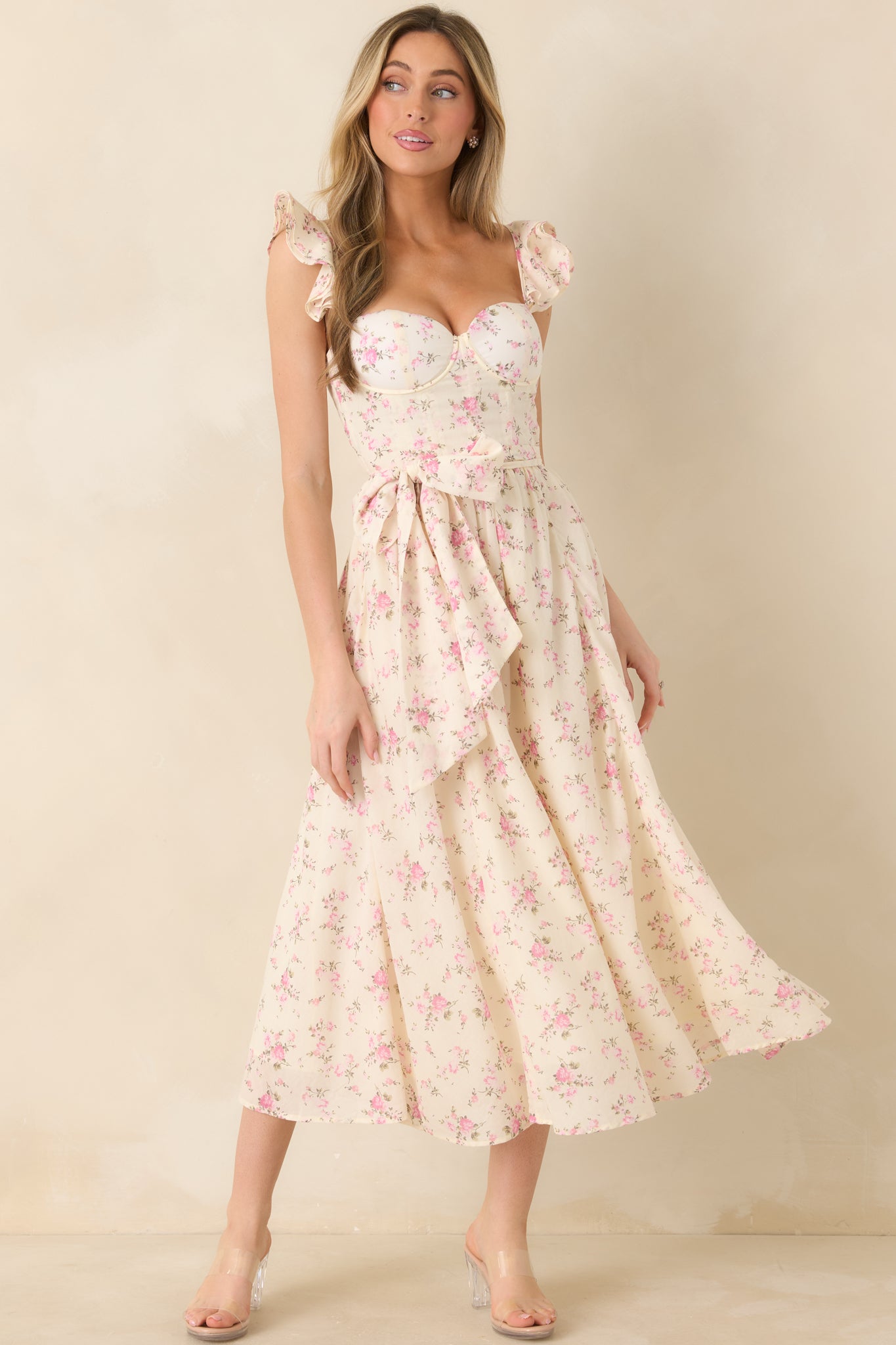 Full-length front shot of a floral maxi dress featuring corset-style boning and adjustable ruffle sleeve straps.