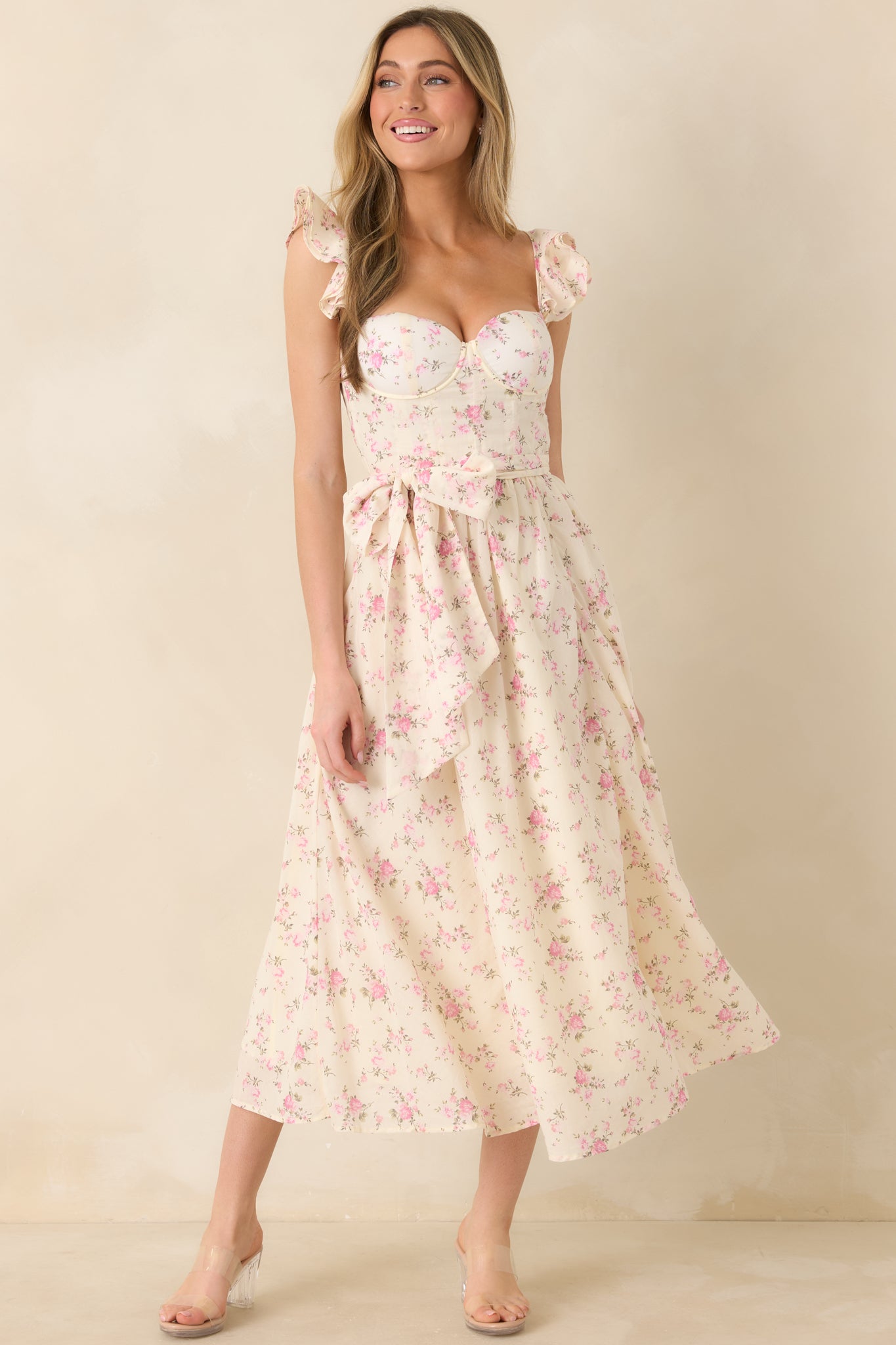 Front-facing view highlighting sweetheart neckline, optional self-tie belt, and full-length skirt of a rose floral maxi dress.