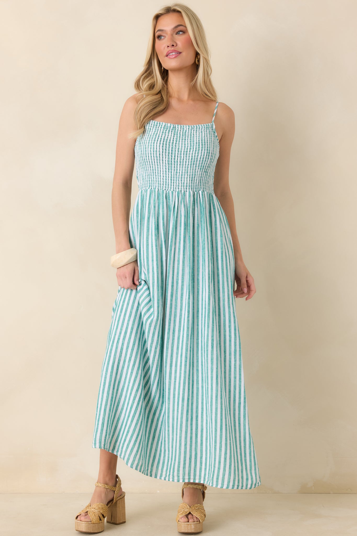 Full-length shot of a breezy maxi dress in textured linen with fitted smocked top and loose skirt.