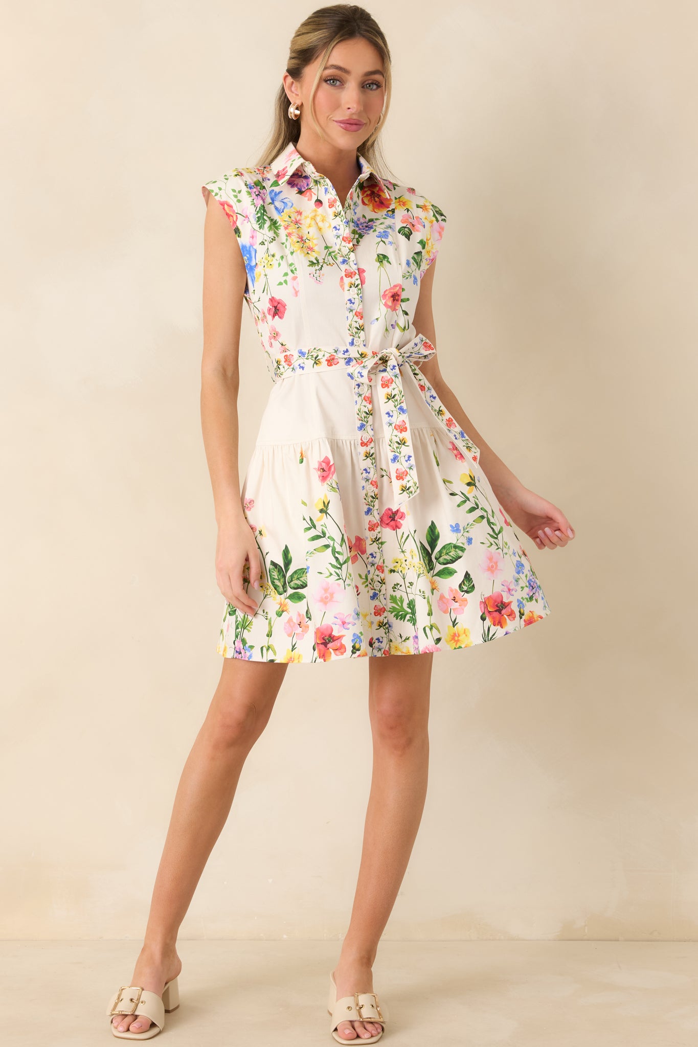 Full-length front view of the white multi floral mini dress highlighting the collared neckline and softly flared skirt.