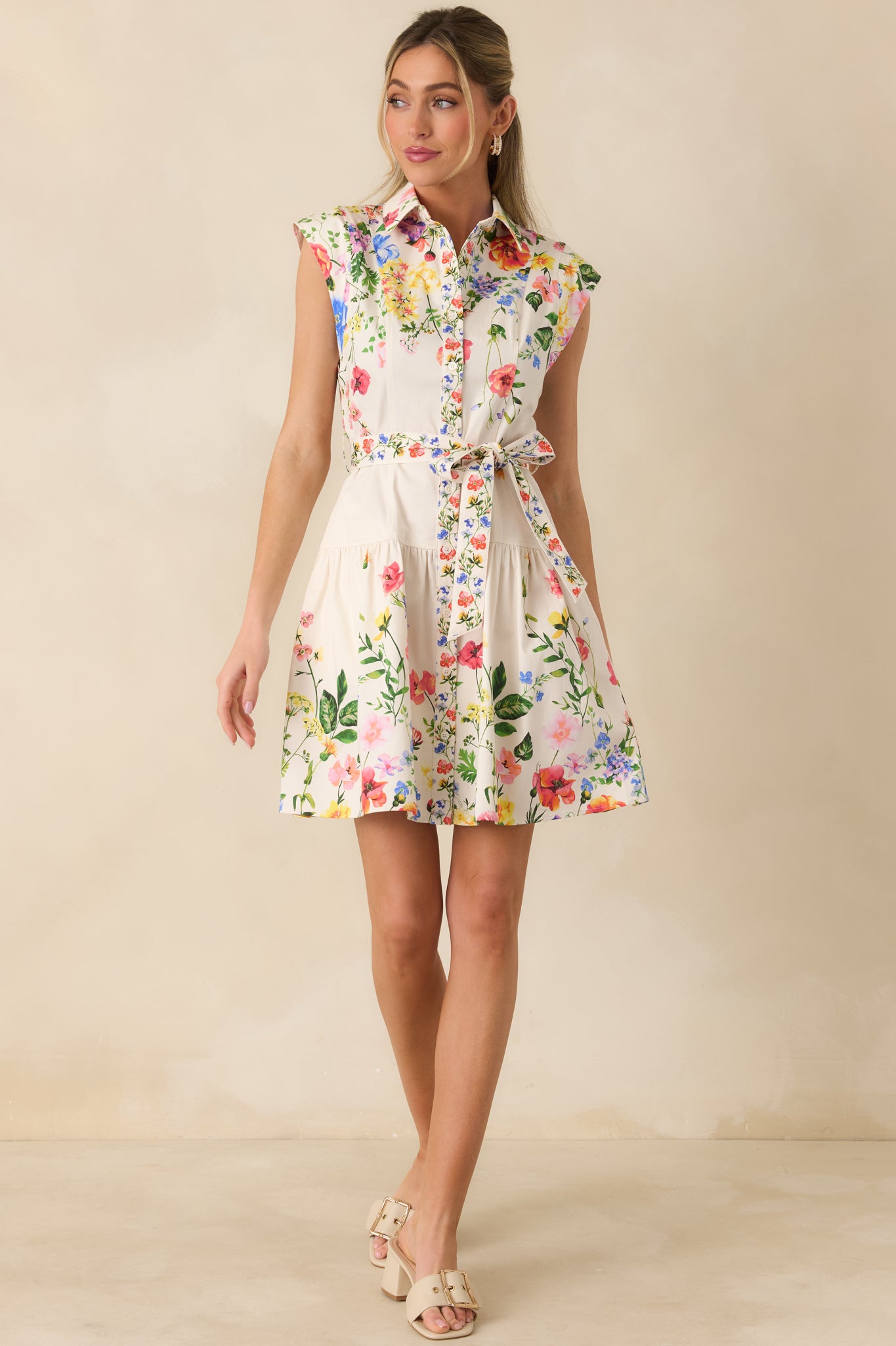 Straight-on view of the white mini dress emphasizing the button-front bodice and lightweight cotton fabric.