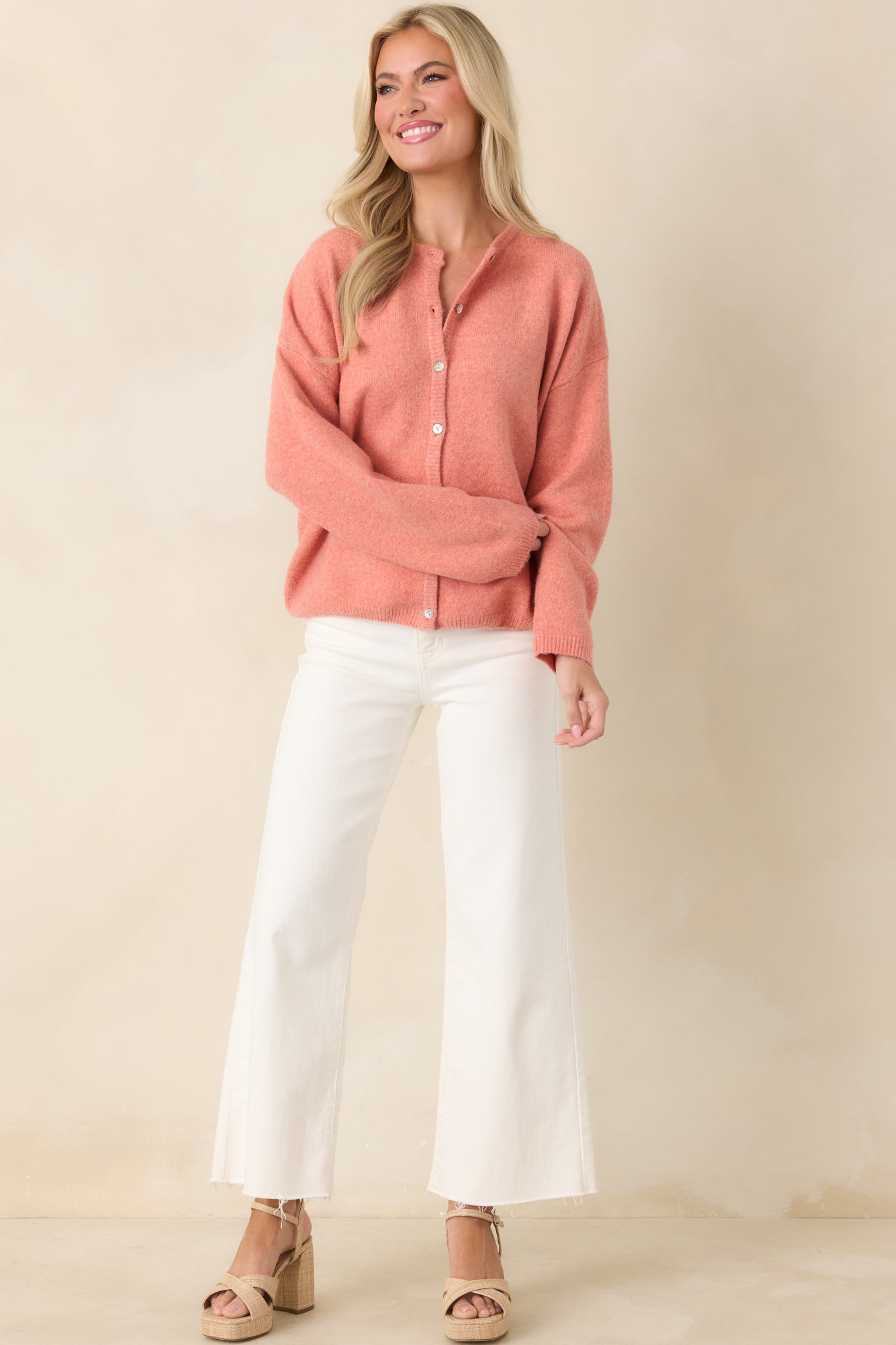 Soft orange cardigan featuring ribbed trim at the neckline, cuffs, and hem, designed for a classic, comfortable fit.