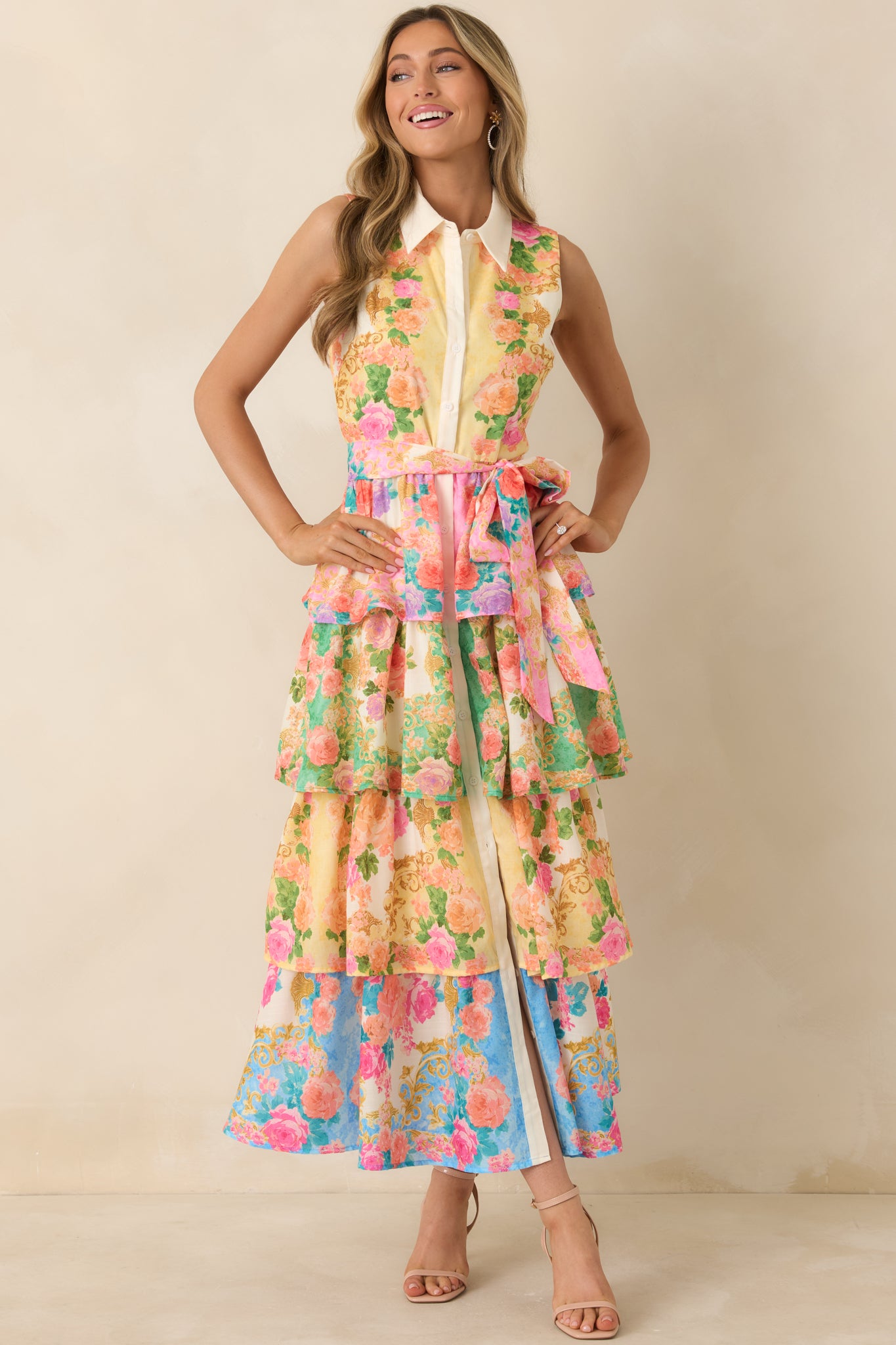 Cheerful yellow dress with sleeveless collared top, tiered skirt, and bright floral pattern.