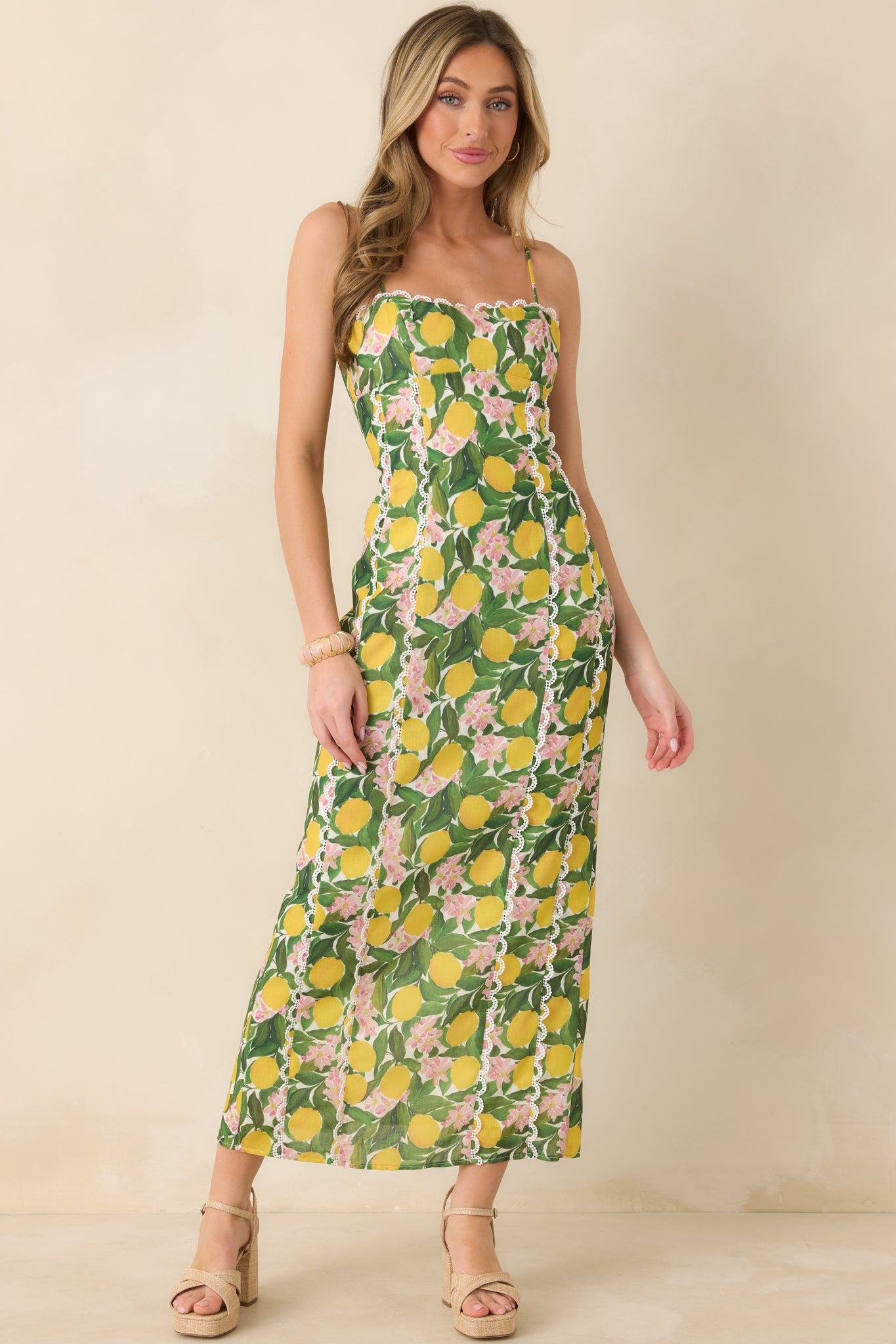 Floral and lemon patterned maxi dress with precise seam detailing, a flattering fitted top, and a straight skirt that falls to a polished maxi hem.