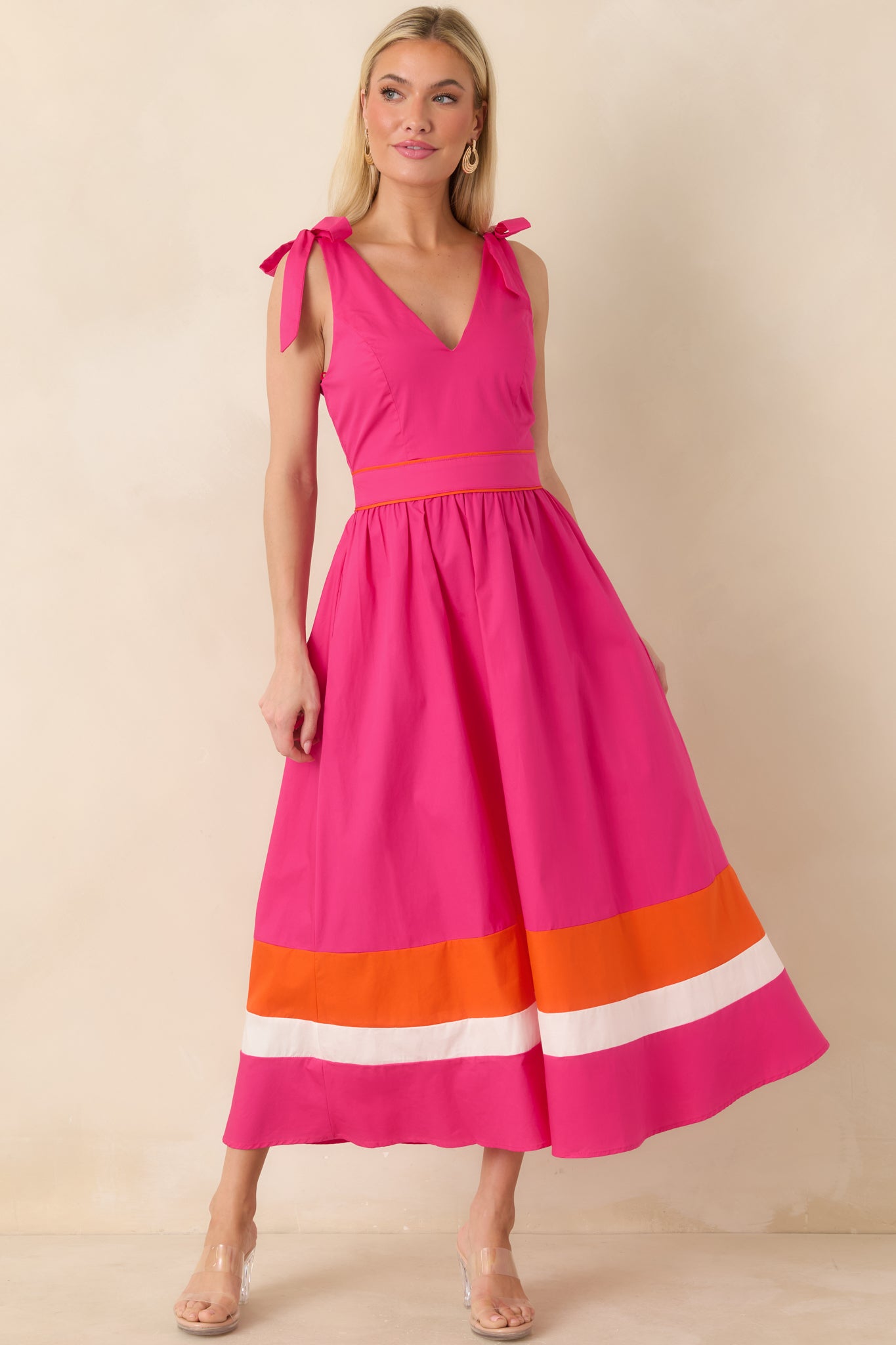 Vibrant fuchsia midi dress with V-neckline and playful contrast colorblock hem.