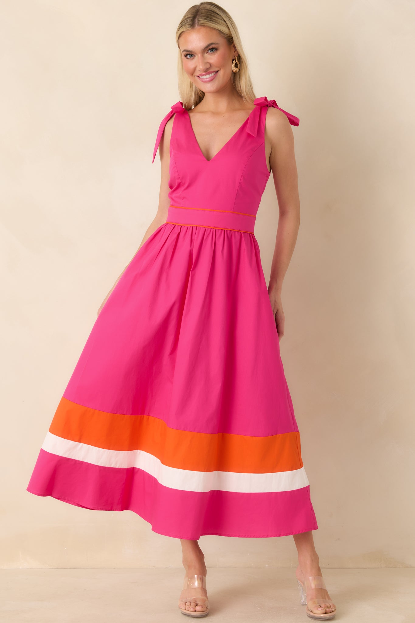 Fuchsia midi dress with adjustable tie straps and breezy skirt with colorblock trim.