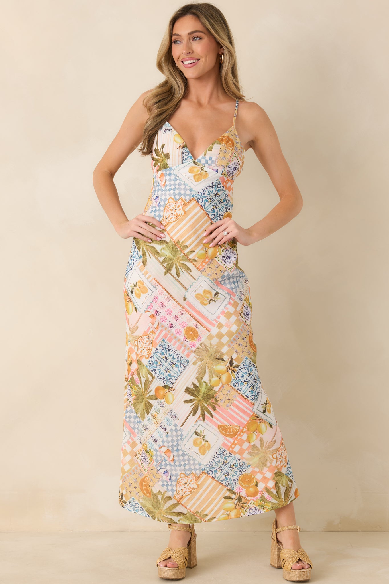 Colorful slip-style dress with tiled and citrus pattern details, designed to skim the body in a minimalist, bias-inspired shape.