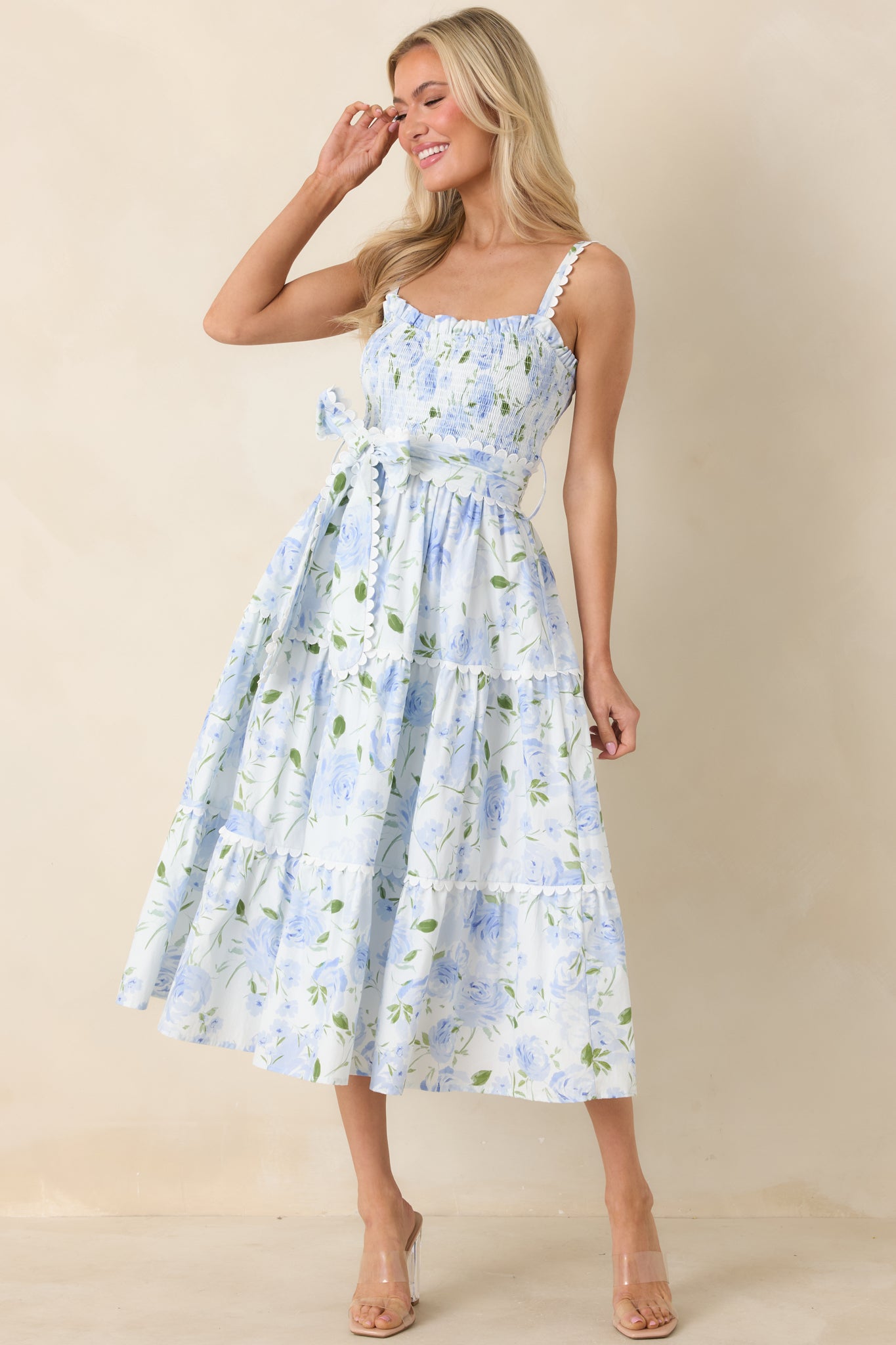 Front angle showcasing tiered skirt design, square neckline, and fitted waist with tie belt.