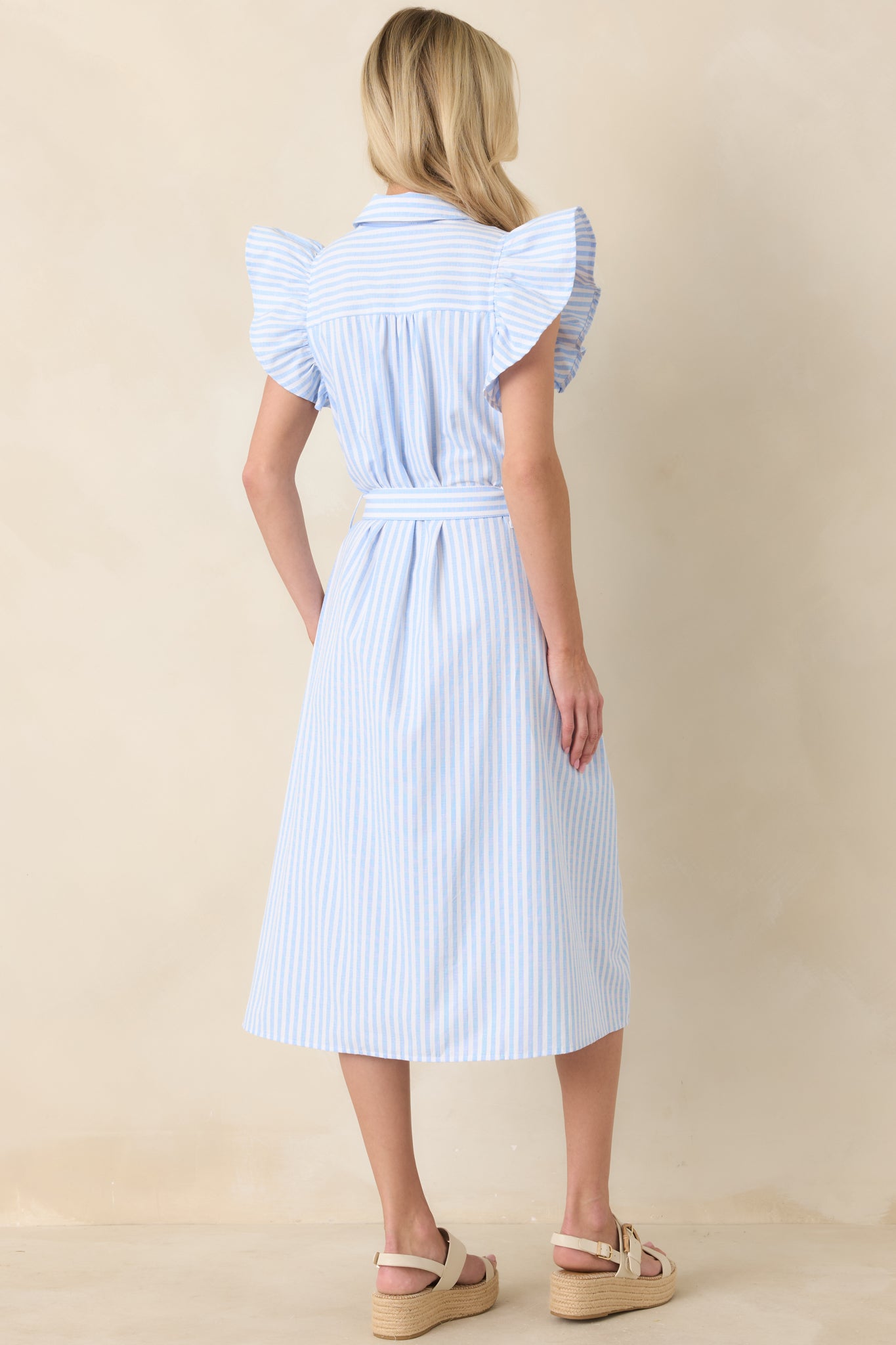 Rear view of dress highlighting smooth silhouette and ruffle sleeve detail.