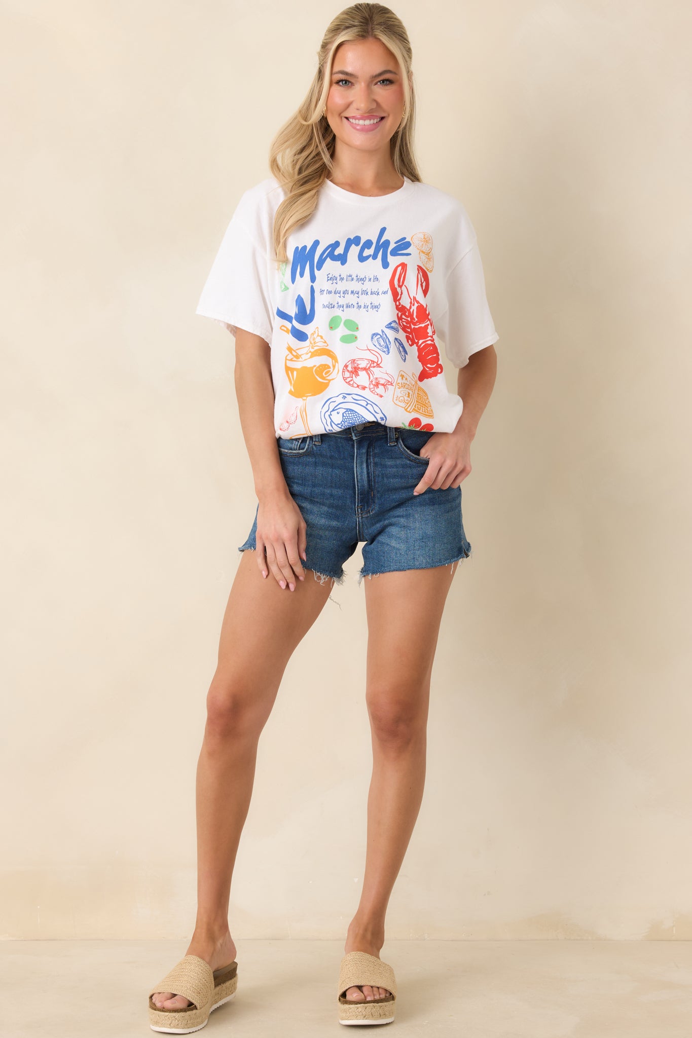 White oversized tee in lightweight cotton with a crew neckline, short sleeves, and a colorful coastal Europe-inspired front graphic.
