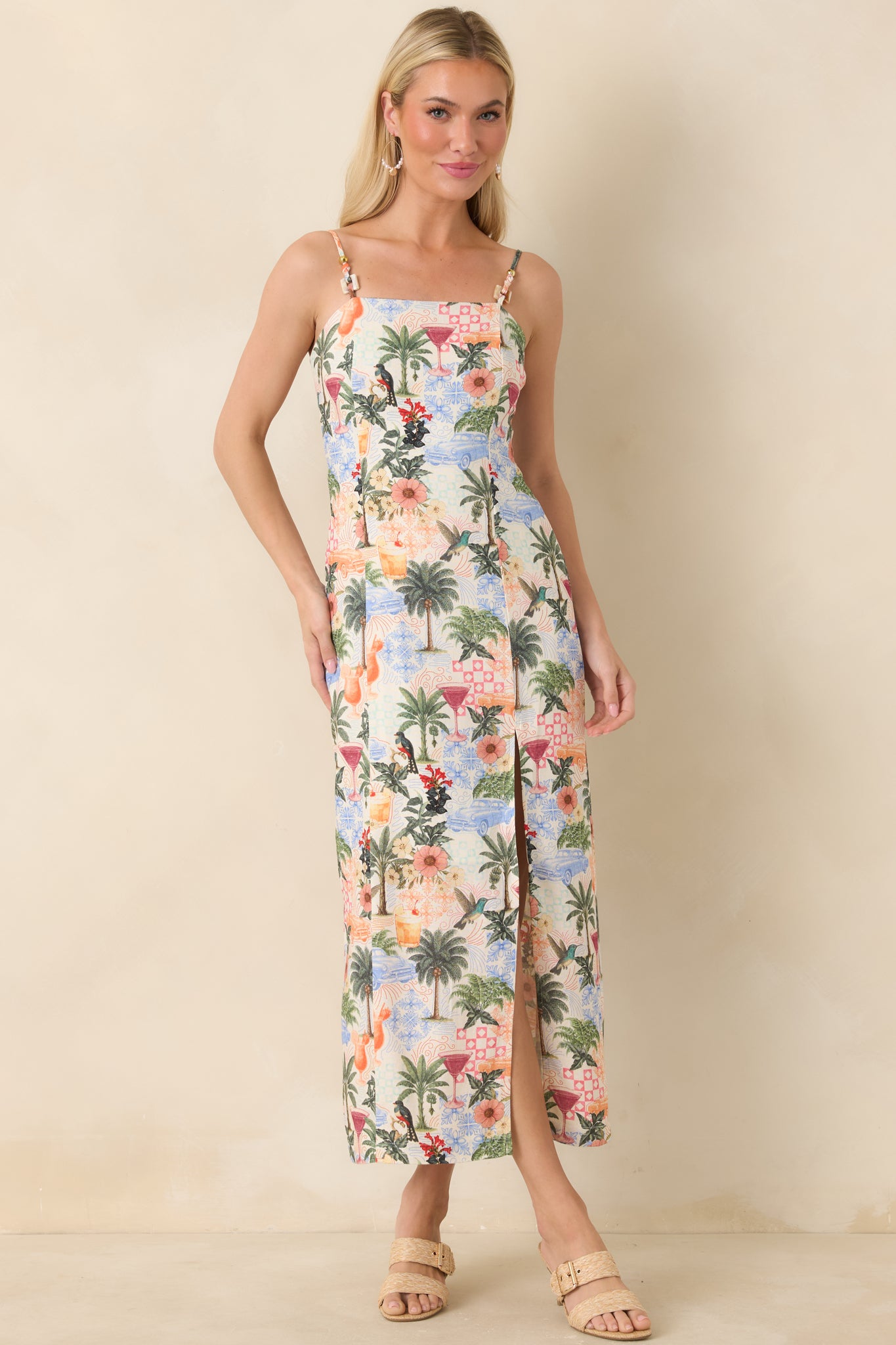 Tropical print midi dress with palm, floral, and cocktail motifs and beaded straps.
