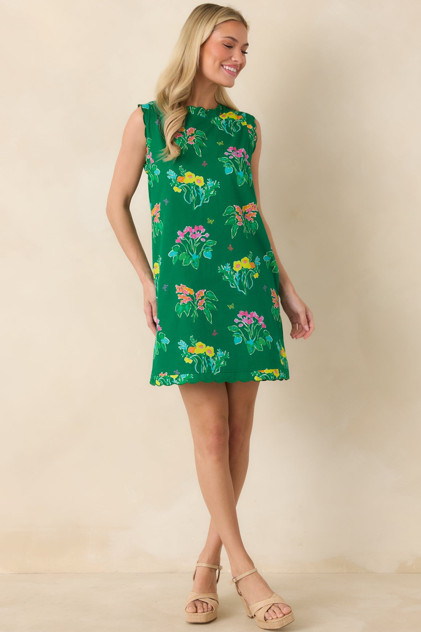 Floral shift dress in bright green with hidden side pockets and comfortable fit.
