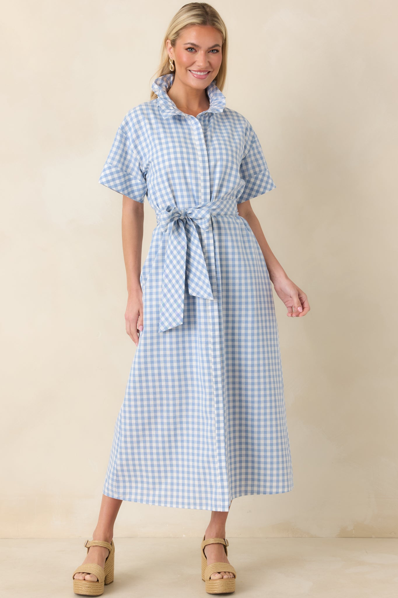 Full-body view of blue and white gingham maxi dress with structured ruffle collar and short sleeves.