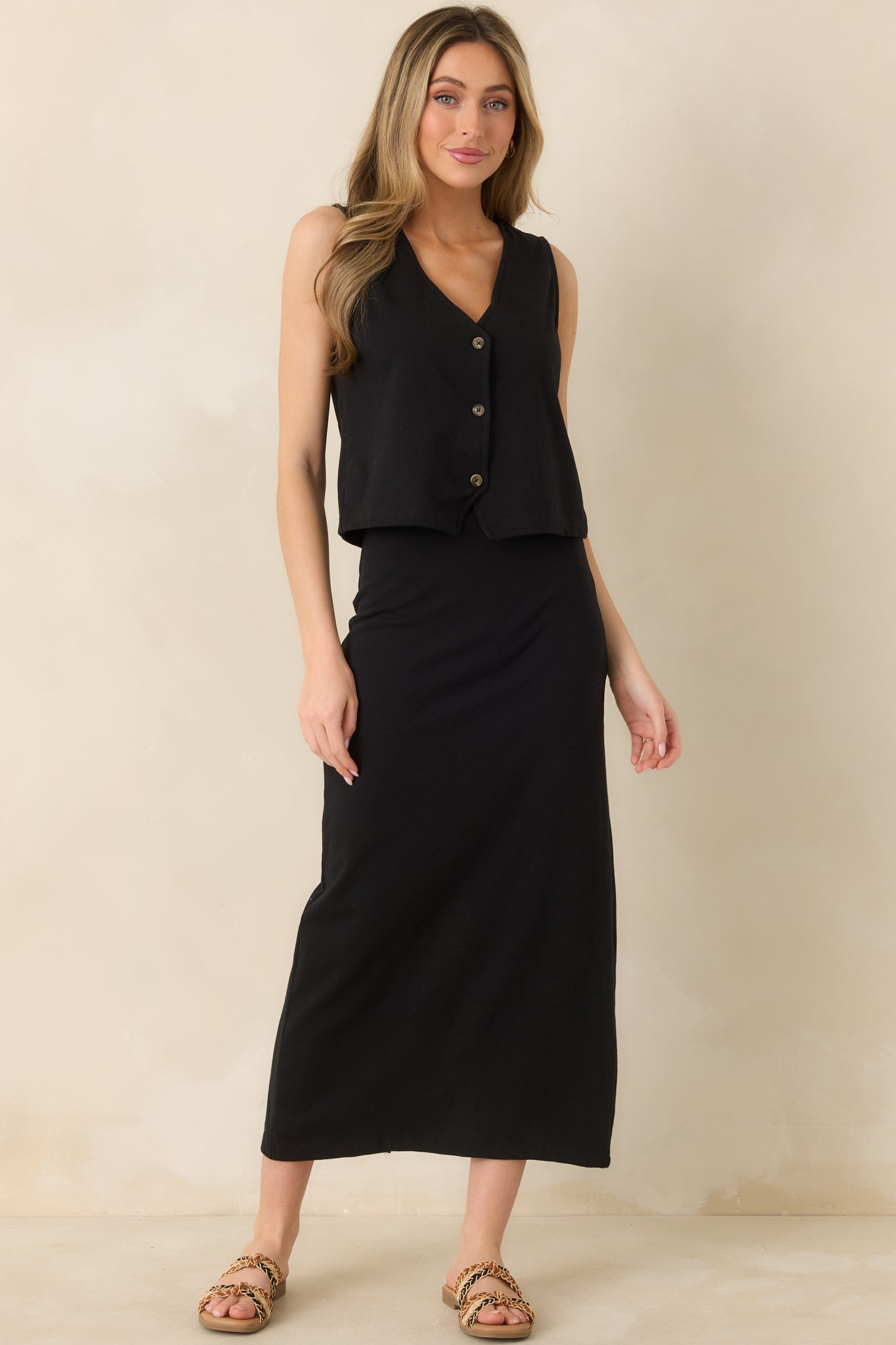 Airy sleeveless top with soft drape, V-neck cut, and simple button-front closure for an effortless look.