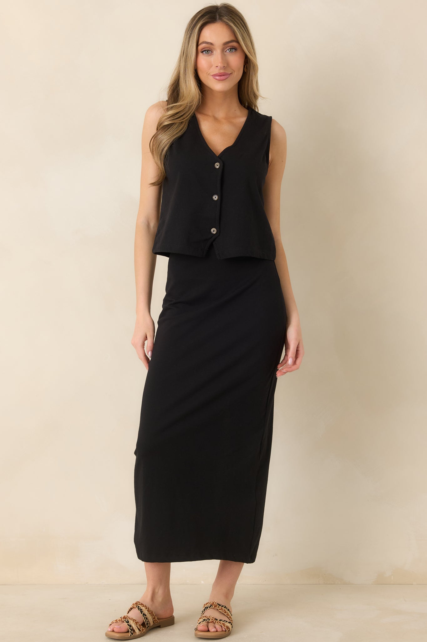 Minimalist sleeveless top with a V-neckline, button-front design, and fluid silhouette.
