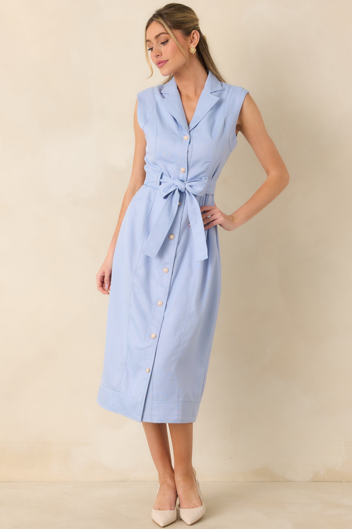 Lightweight woven blue midi dress with tailored lapel collar, full button-front detail, and a streamlined belted silhouette.