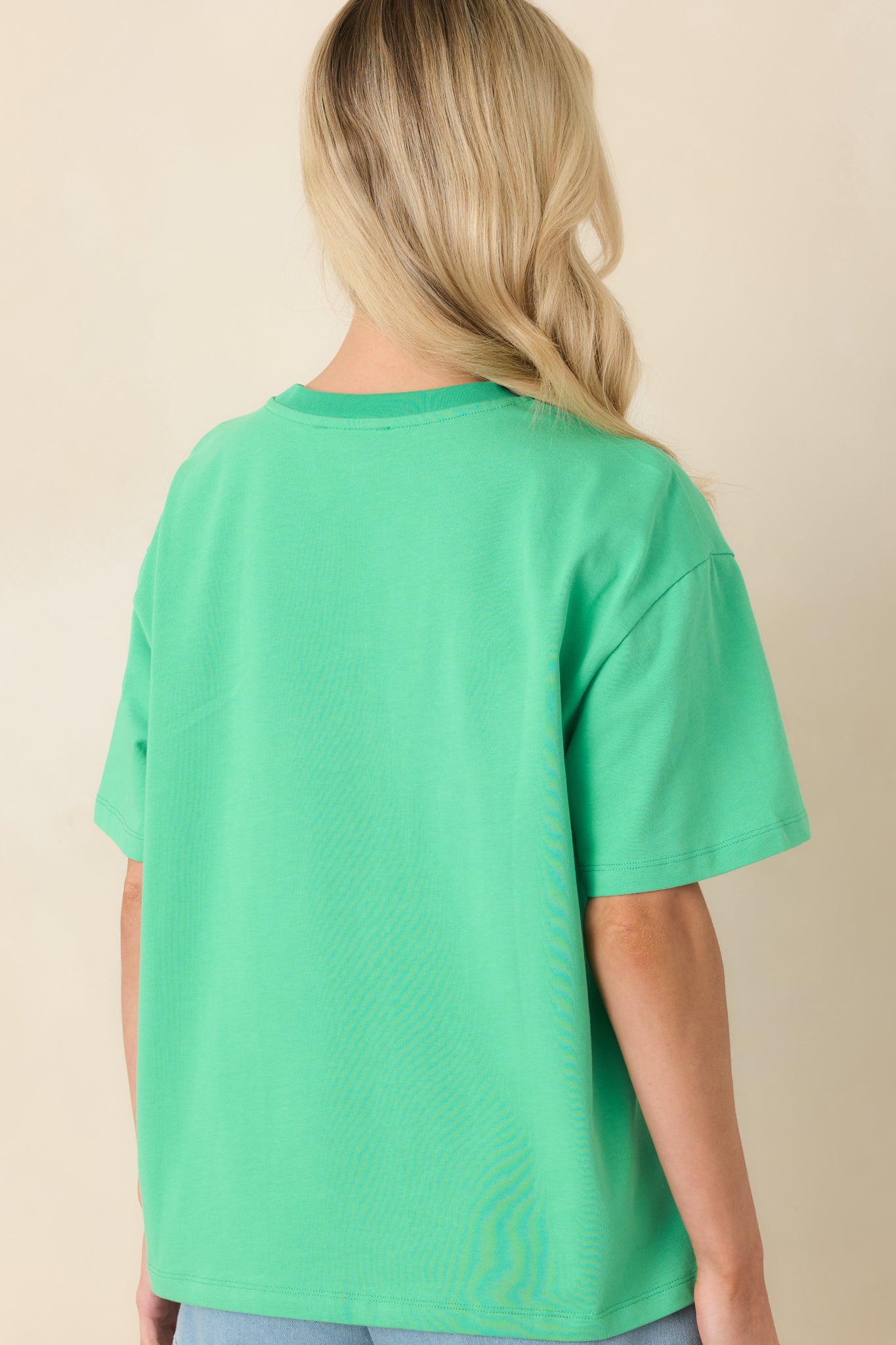 Rear view of the relaxed-fit cotton tee featuring a clean, unembellished design with a classic crew neckline and short sleeves in soft breathable fabric.