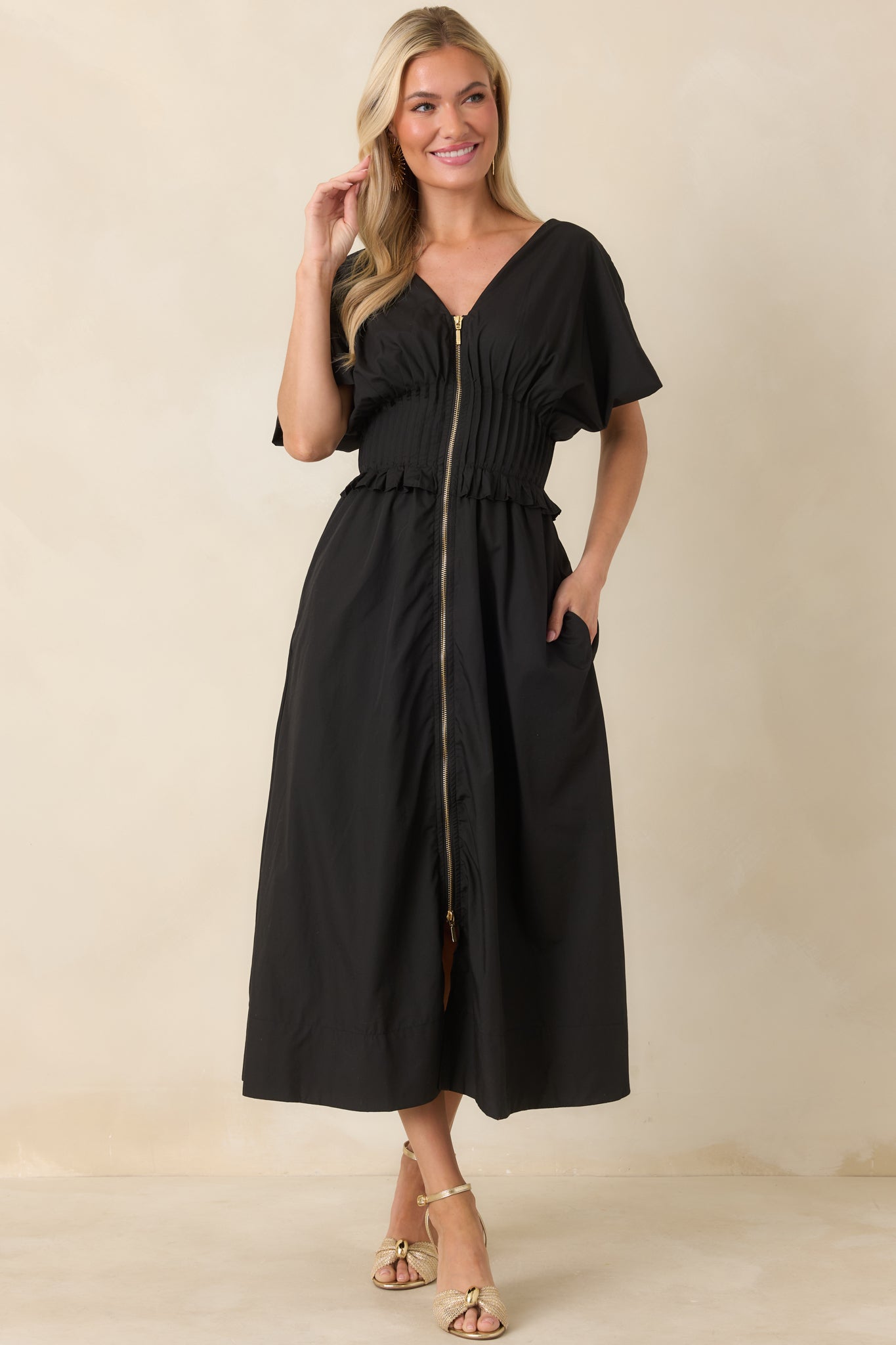 Black maxi dress designed with short sleeves, V-neckline, and a flowing A-line skirt for effortless wear.