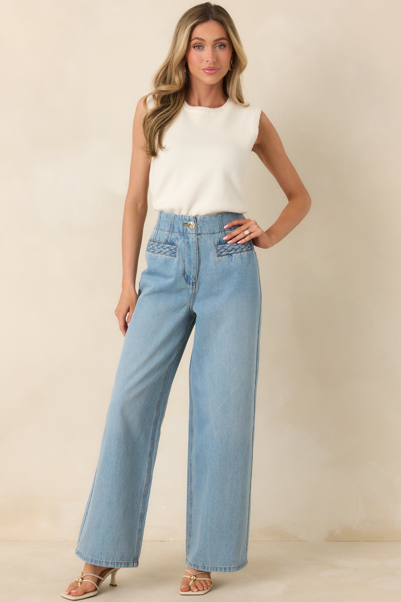 Soft light denim jeans featuring a straight-leg cut, subtle vintage-inspired details, and a high-rise fit for elongation.