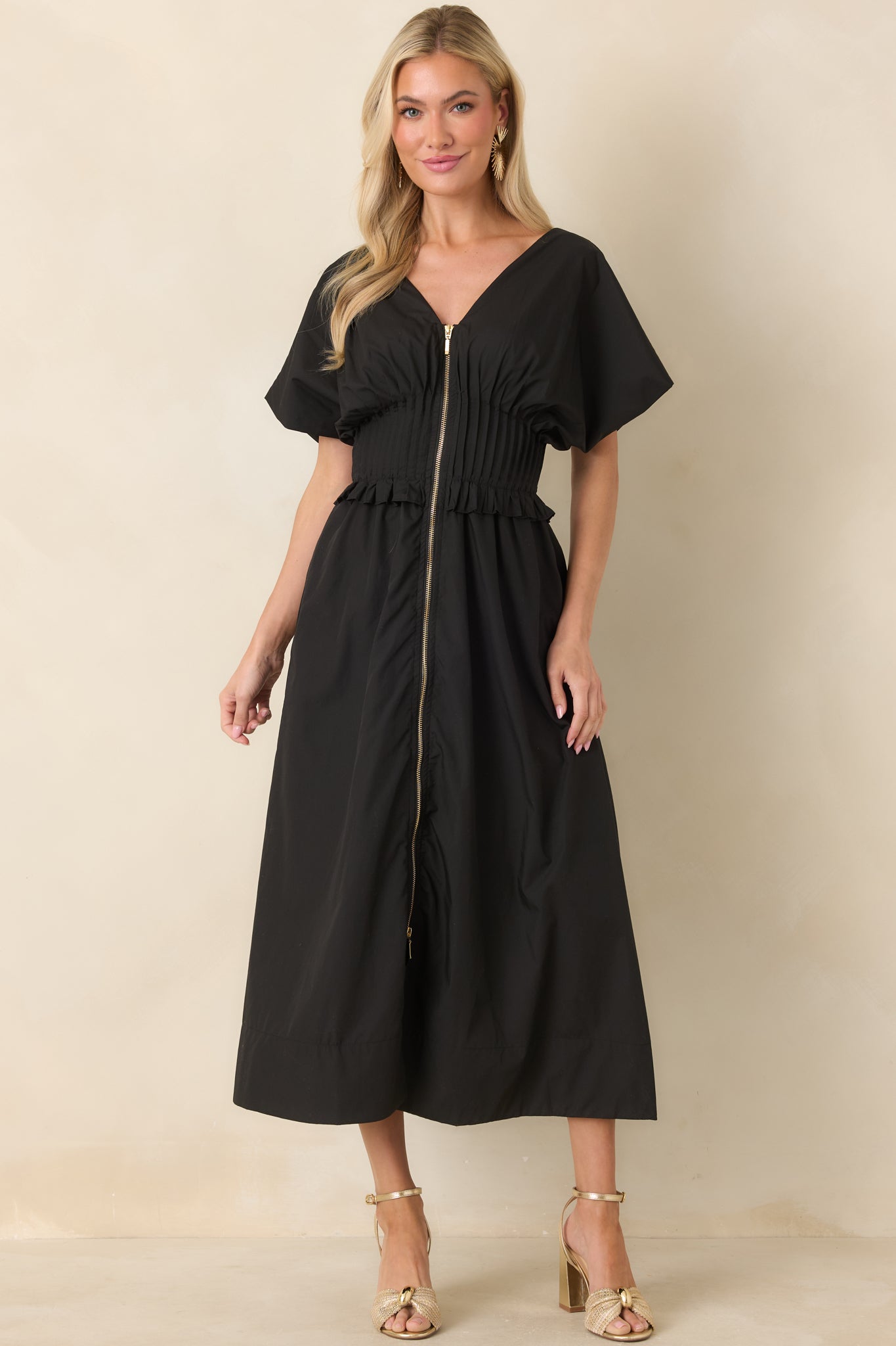 Front-zip maxi dress in black featuring short sleeves, a fitted smocked waist, and a relaxed skirt.