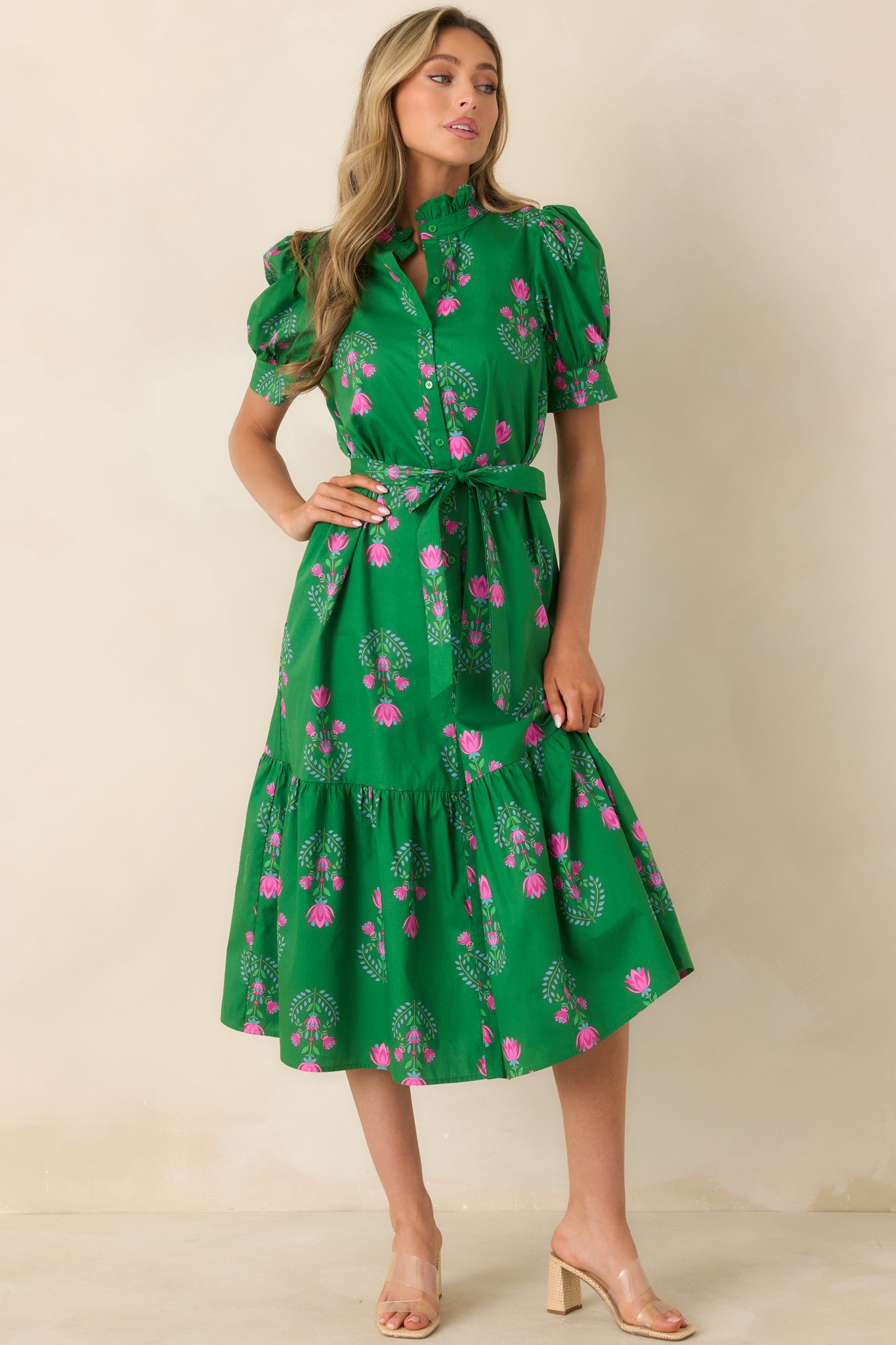 Green floral midi dress featuring high neckline ruffle, removable waist tie, and full A-line tiered skirt.