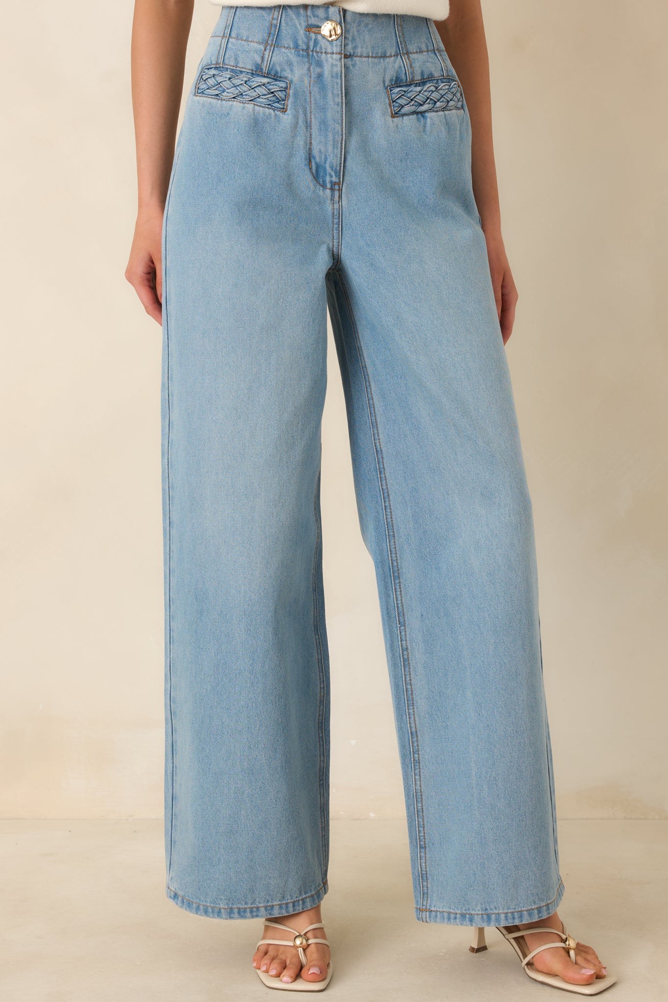 Focus on the straight-leg silhouette and smooth light wash finish, emphasizing casual, wearable styling.