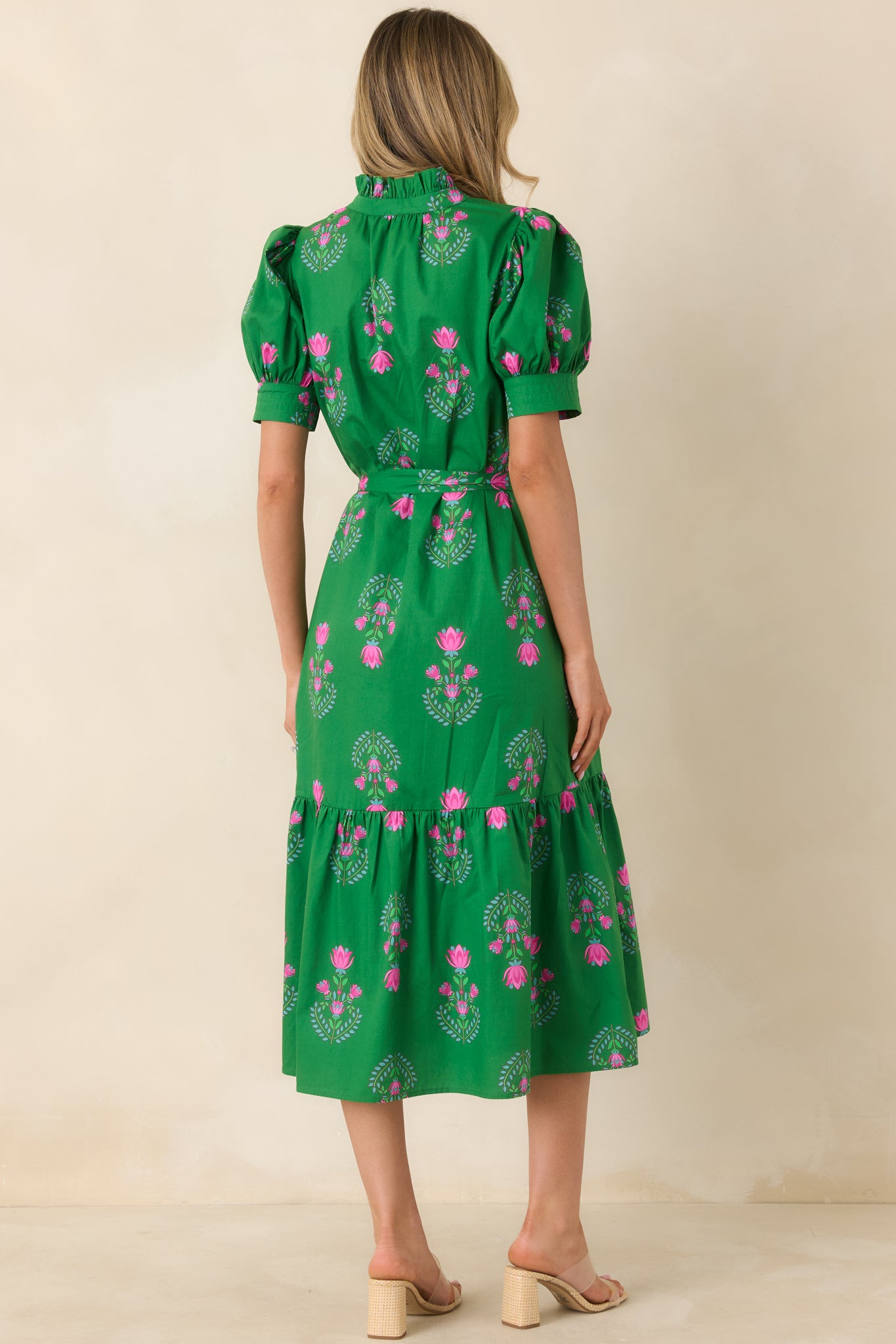 Back view of the green midi dress showing puff sleeves, tiered skirt, and smooth back silhouette with self-tie belt.