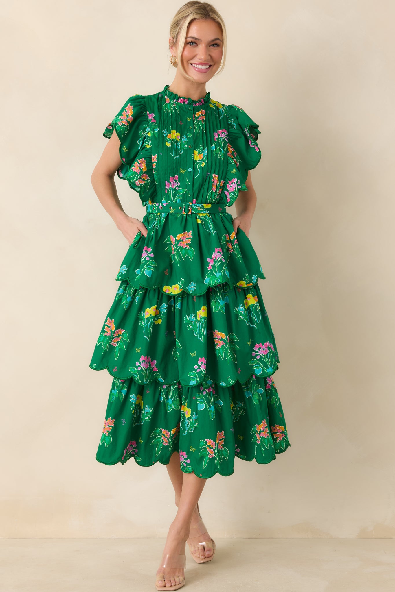 Cotton dress featuring flutter sleeves and scalloped tiered ruffles along the skirt.