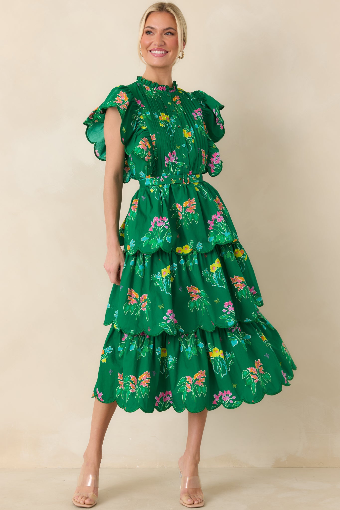 Breezy floral dress with pleated bodice, soft flutter sleeves, and tiered skirt details.