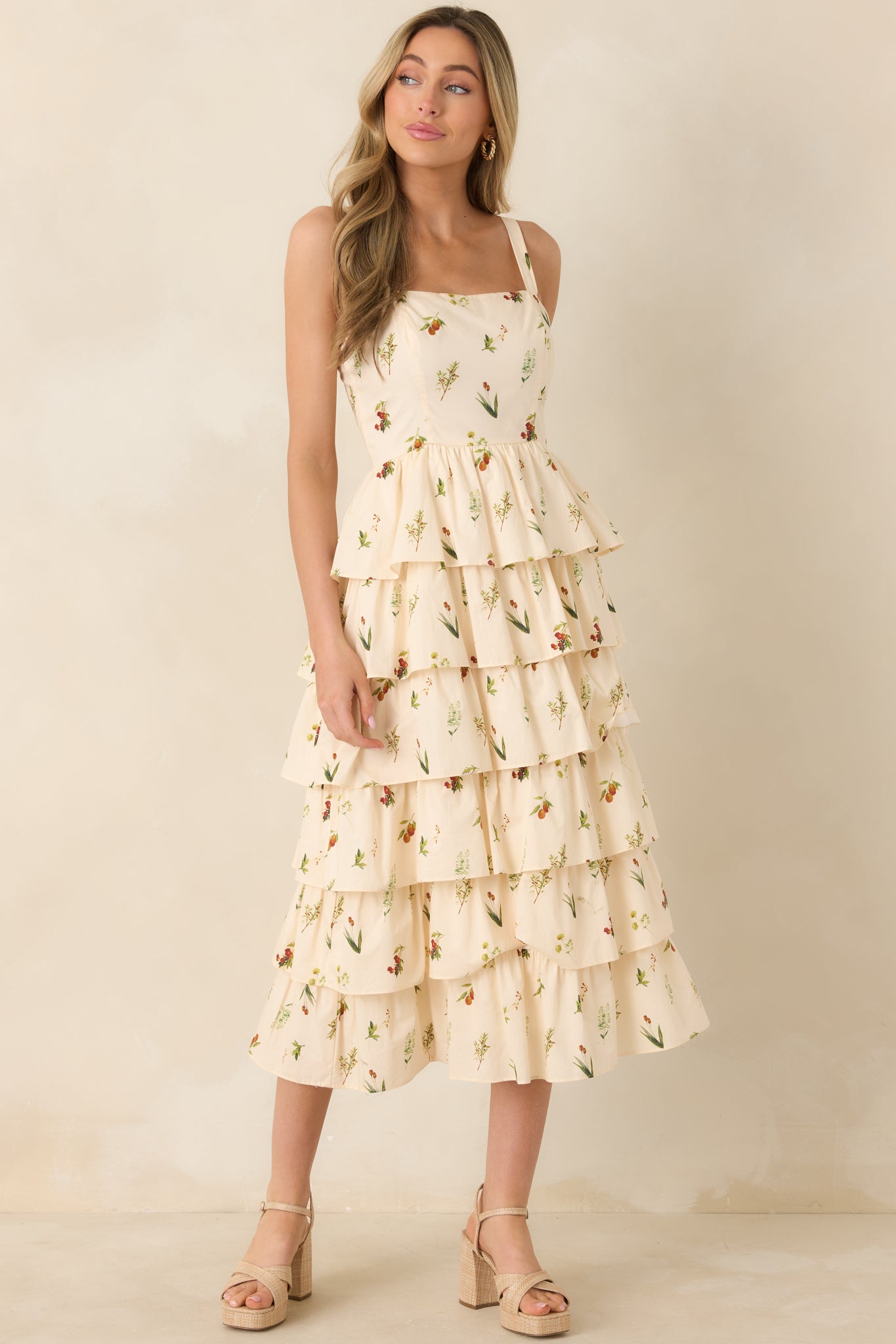 Sleeveless ivory midi dress featuring elastic shoulder strap inserts and paneled bodice design.