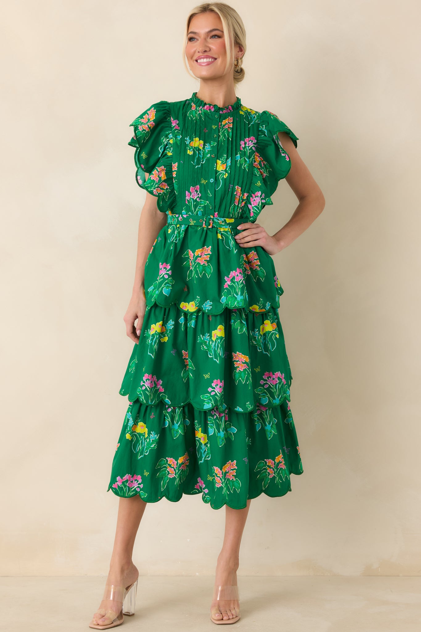 Elegant cotton midi featuring scalloped ruffles, coordinating belt, and bright floral pattern.