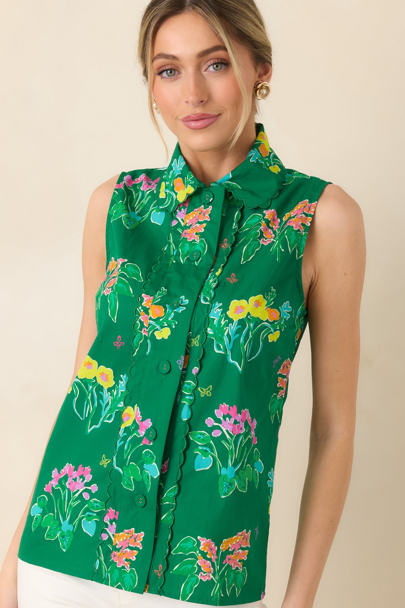 Detailed look at scalloped trim along neckline and placket of lightweight cotton top.