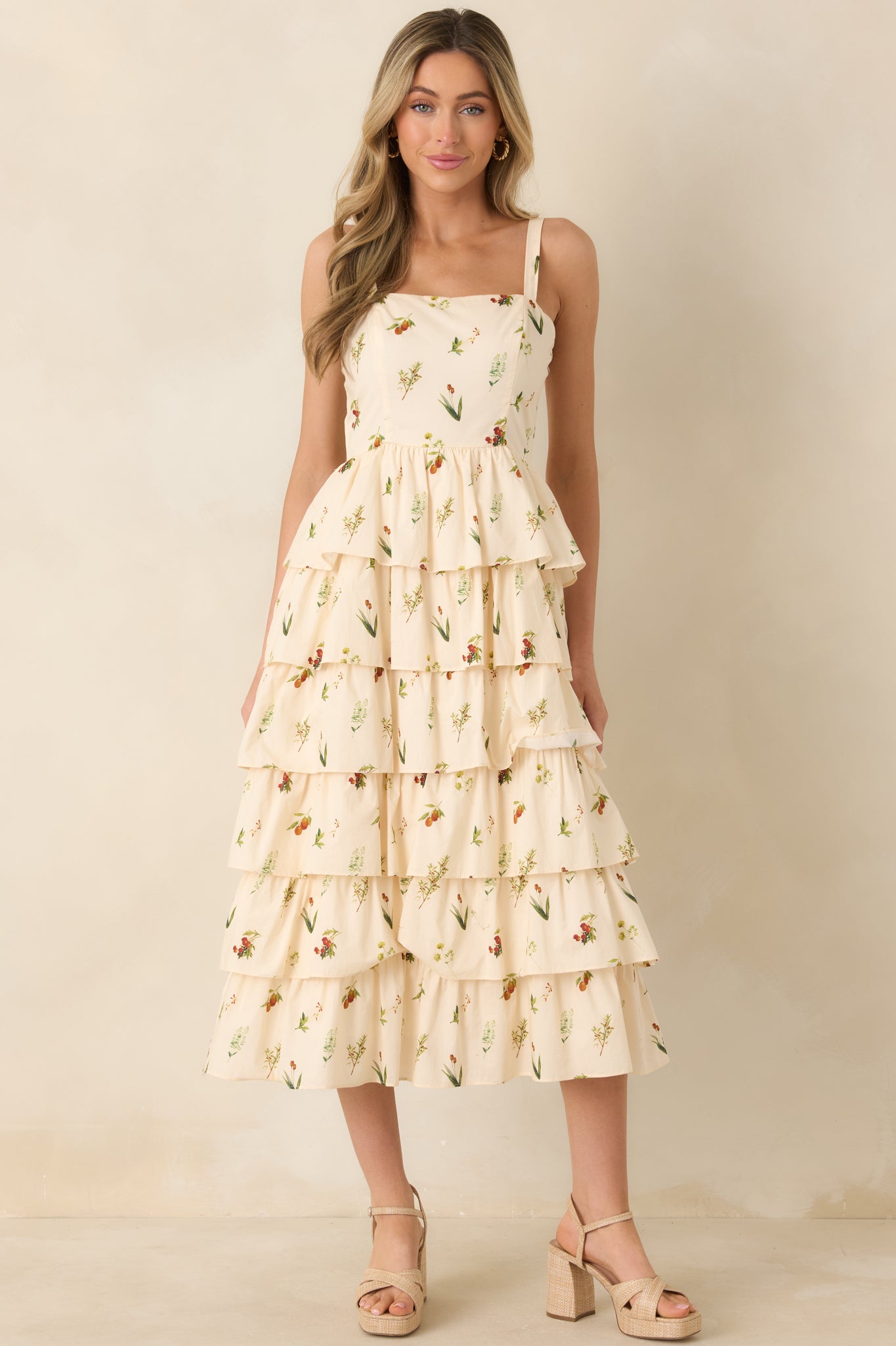 Front view of floral midi dress with fitted bodice, flowing tiered skirt, and square neckline.