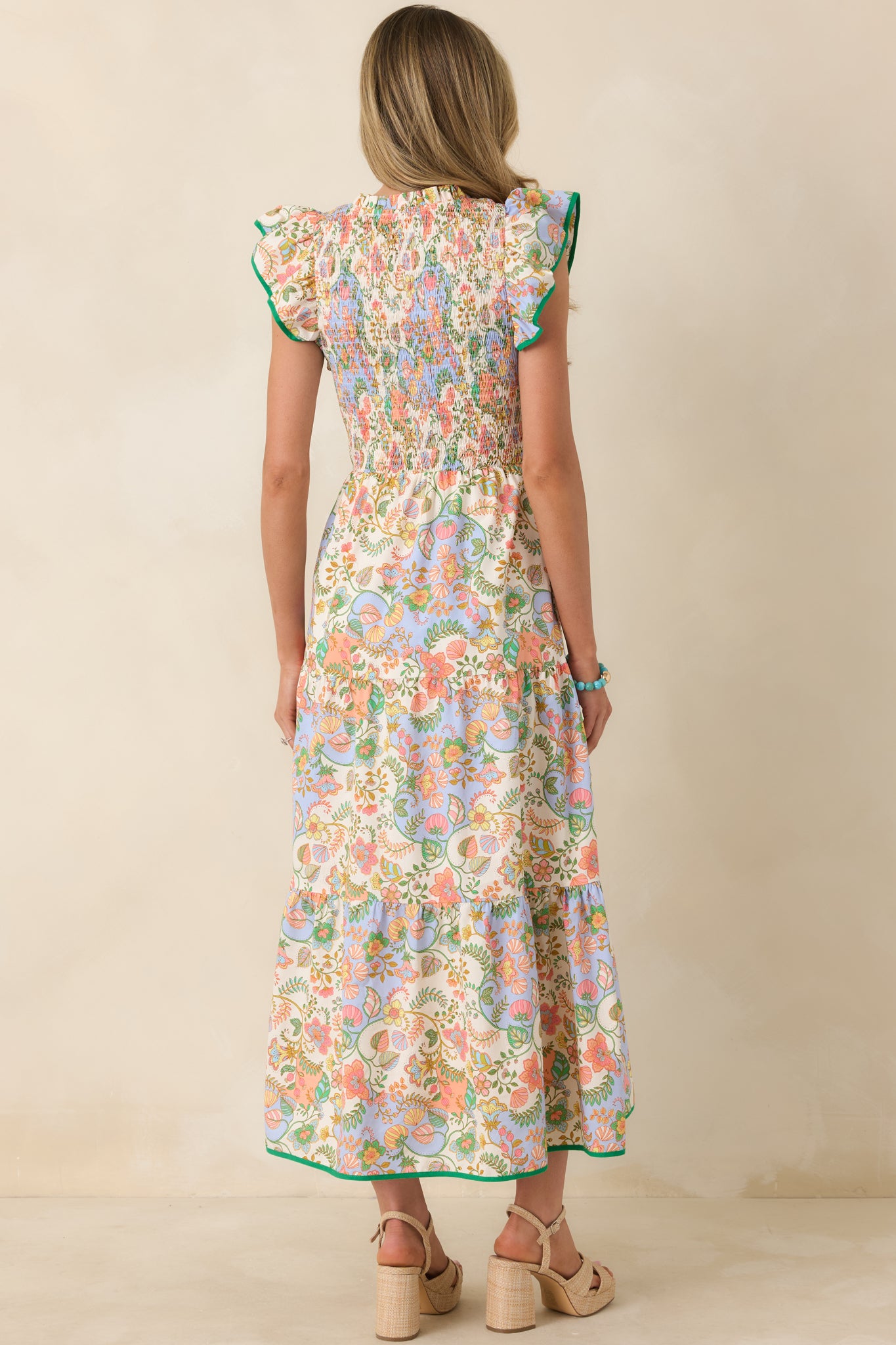 Rear view of the floral paisley maxi dress displaying the fully smocked bodice and the softly tiered skirt cascading to a flowing hem.