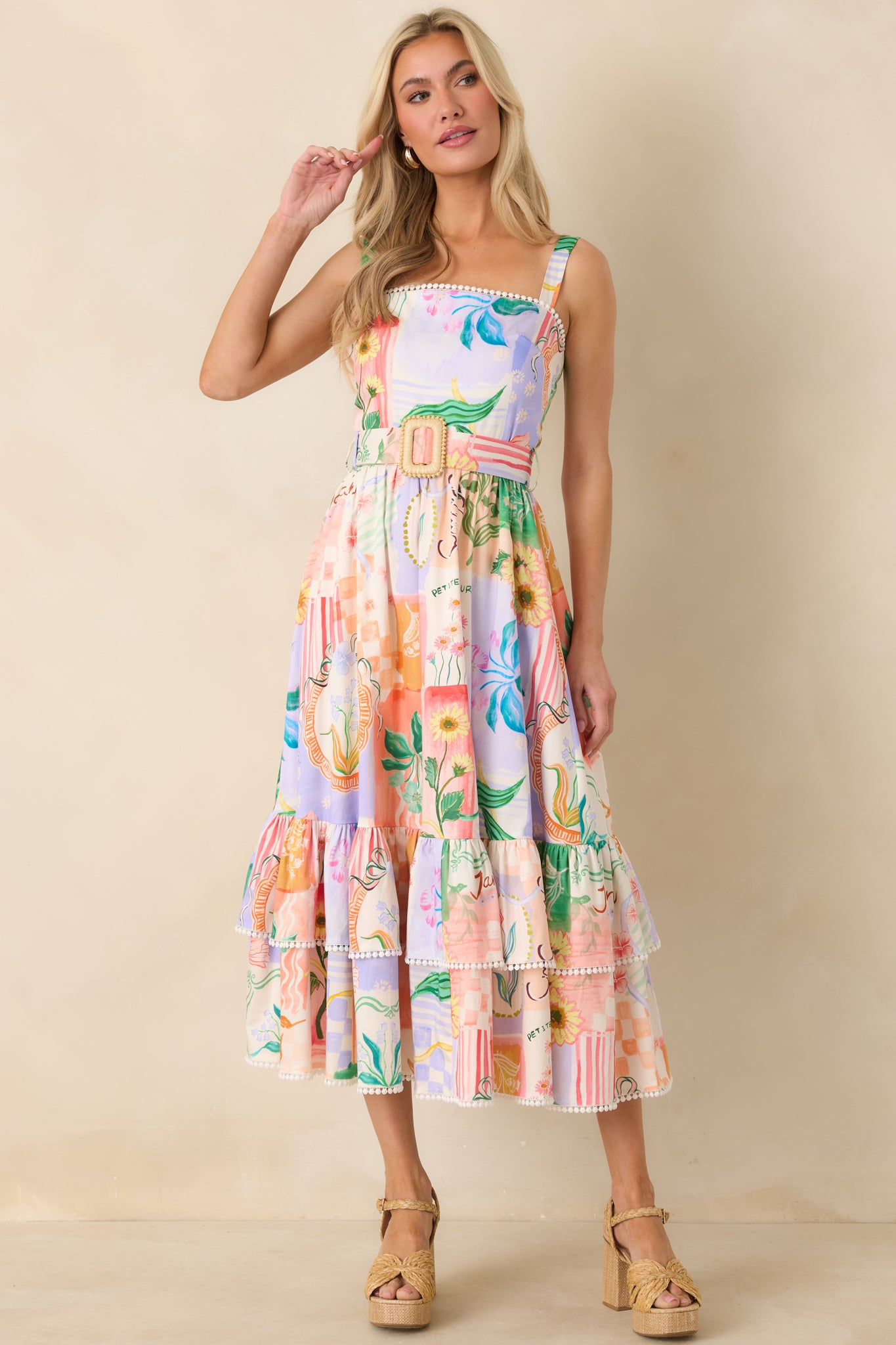 Peach multicolored midi dress with adjustable shoulder straps, softly structured bodice, and flowing tiered skirt.