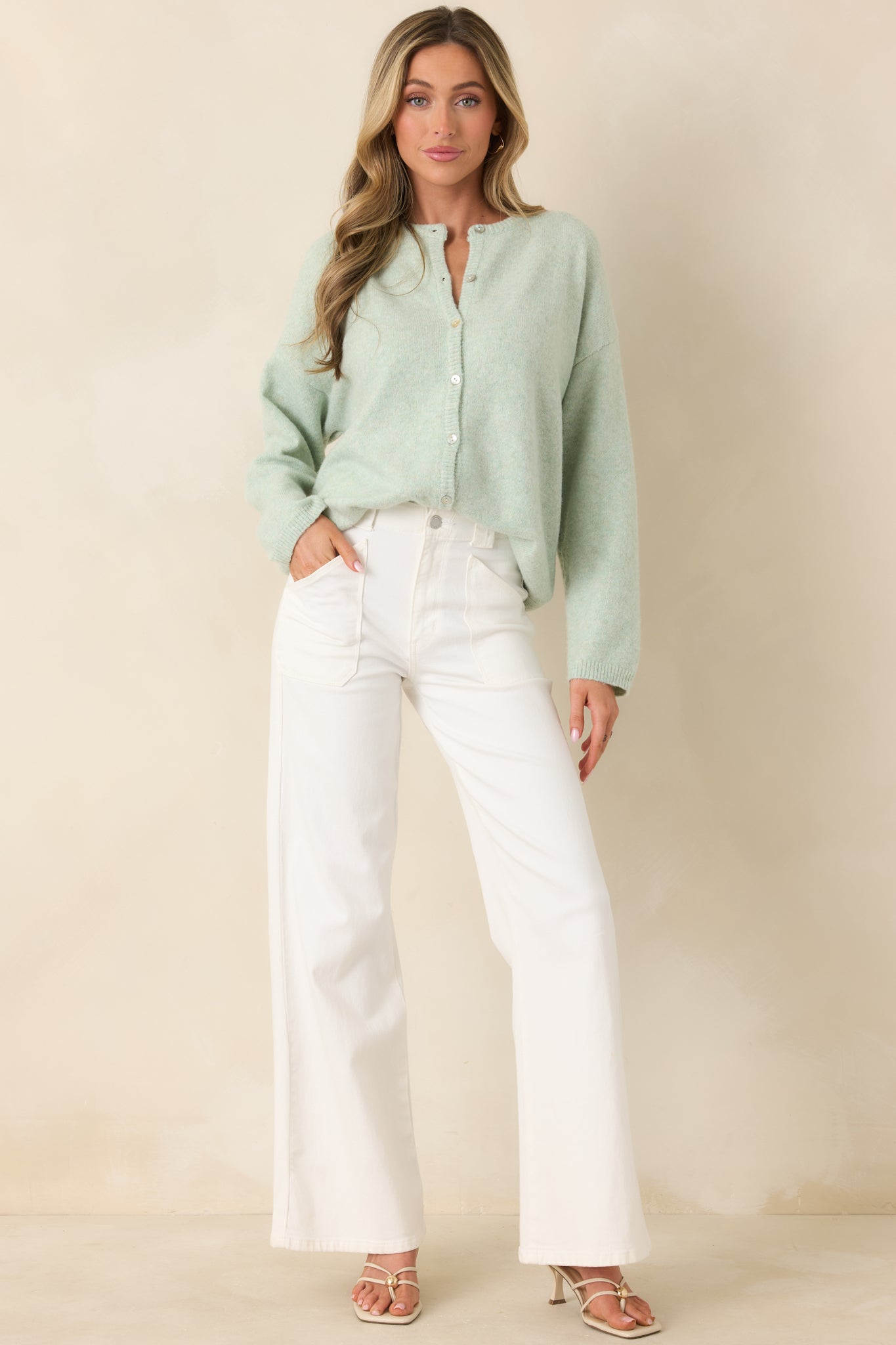 Mint green cardigan in soft knit with a button-front closure, round neckline, and long sleeves for a relaxed, classic fit.